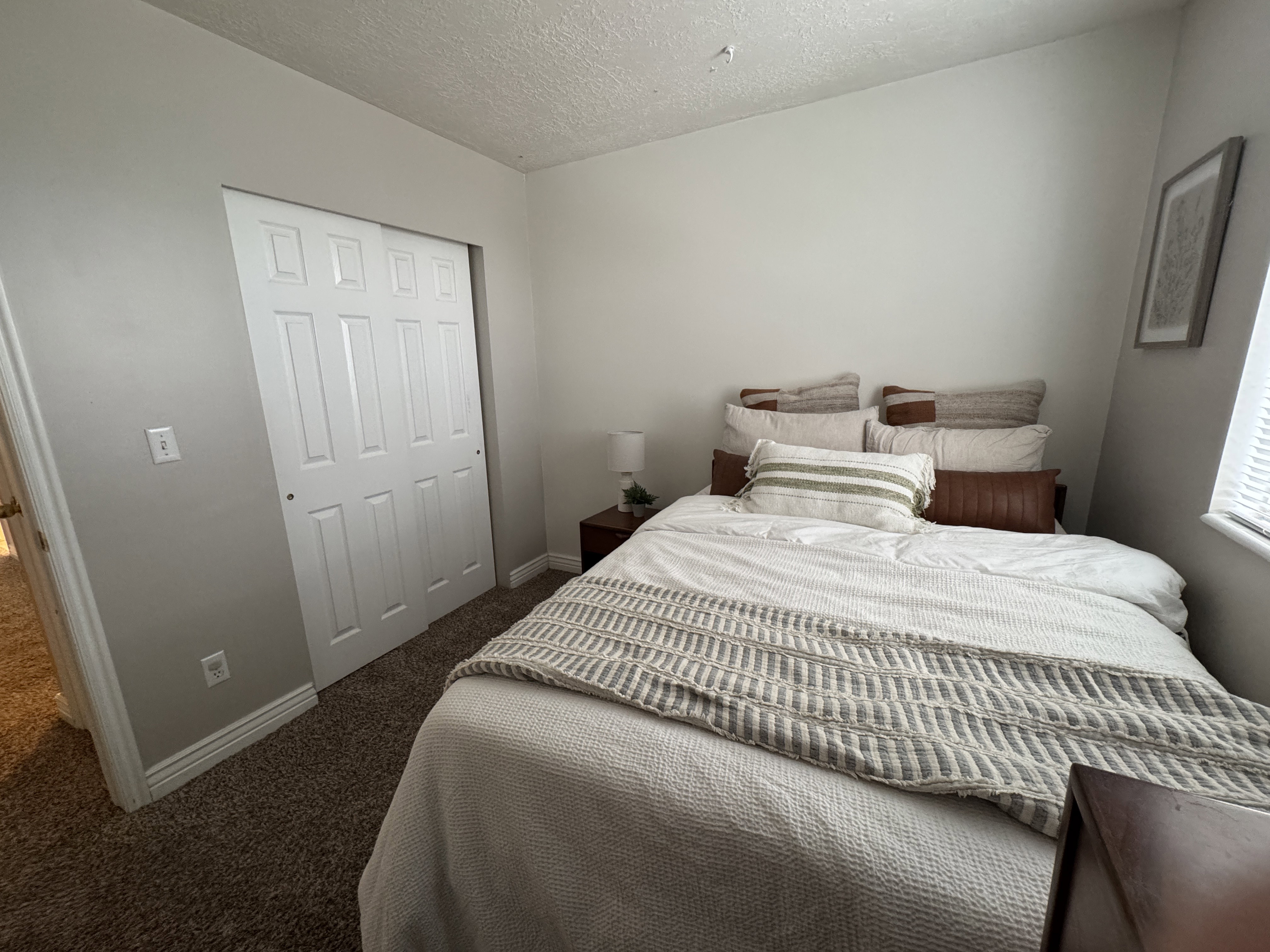Interior room featuring light gray walls and dark brown carpet