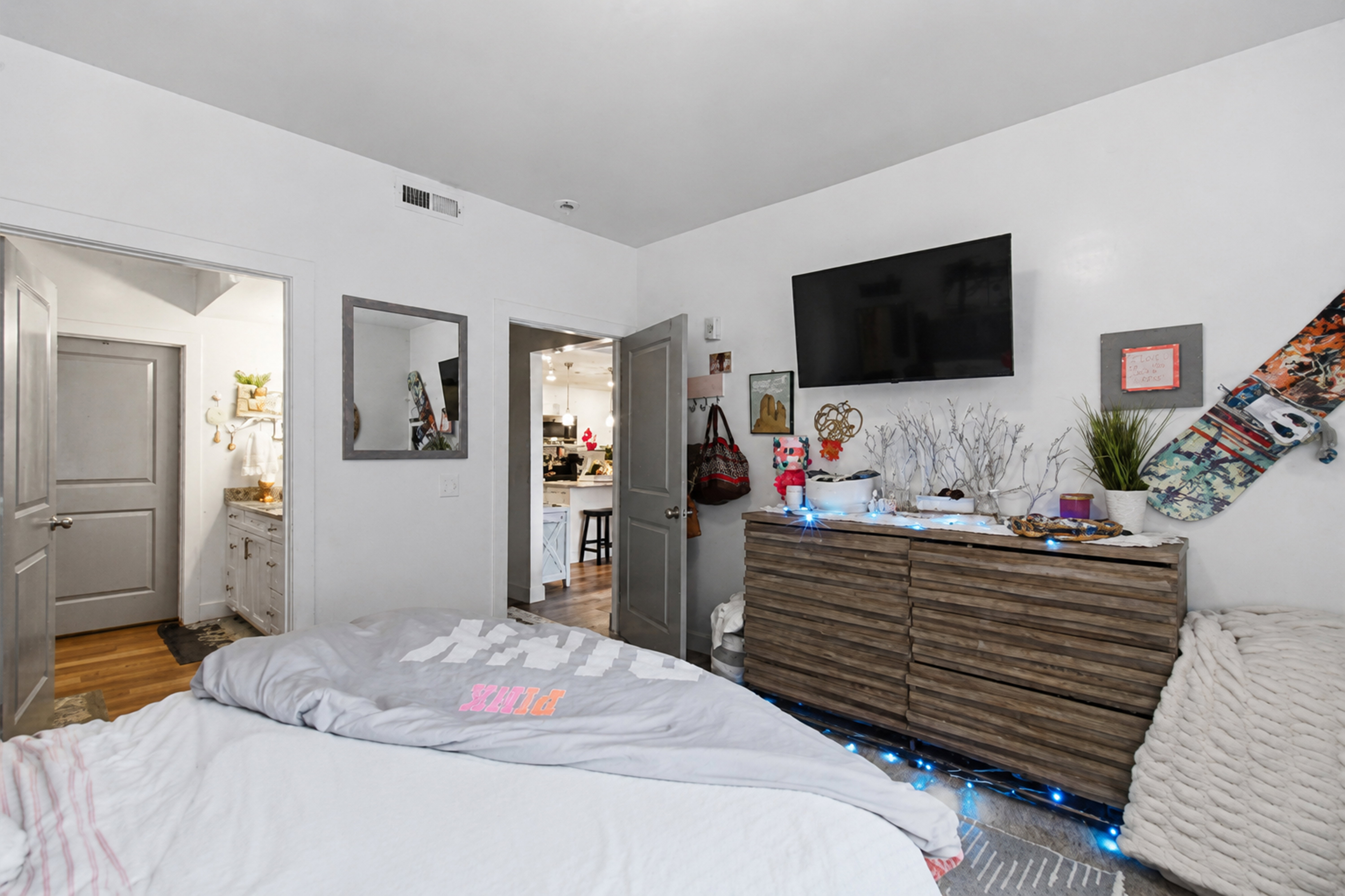 Bedroom featuring light gray walls and wood-finish flooring