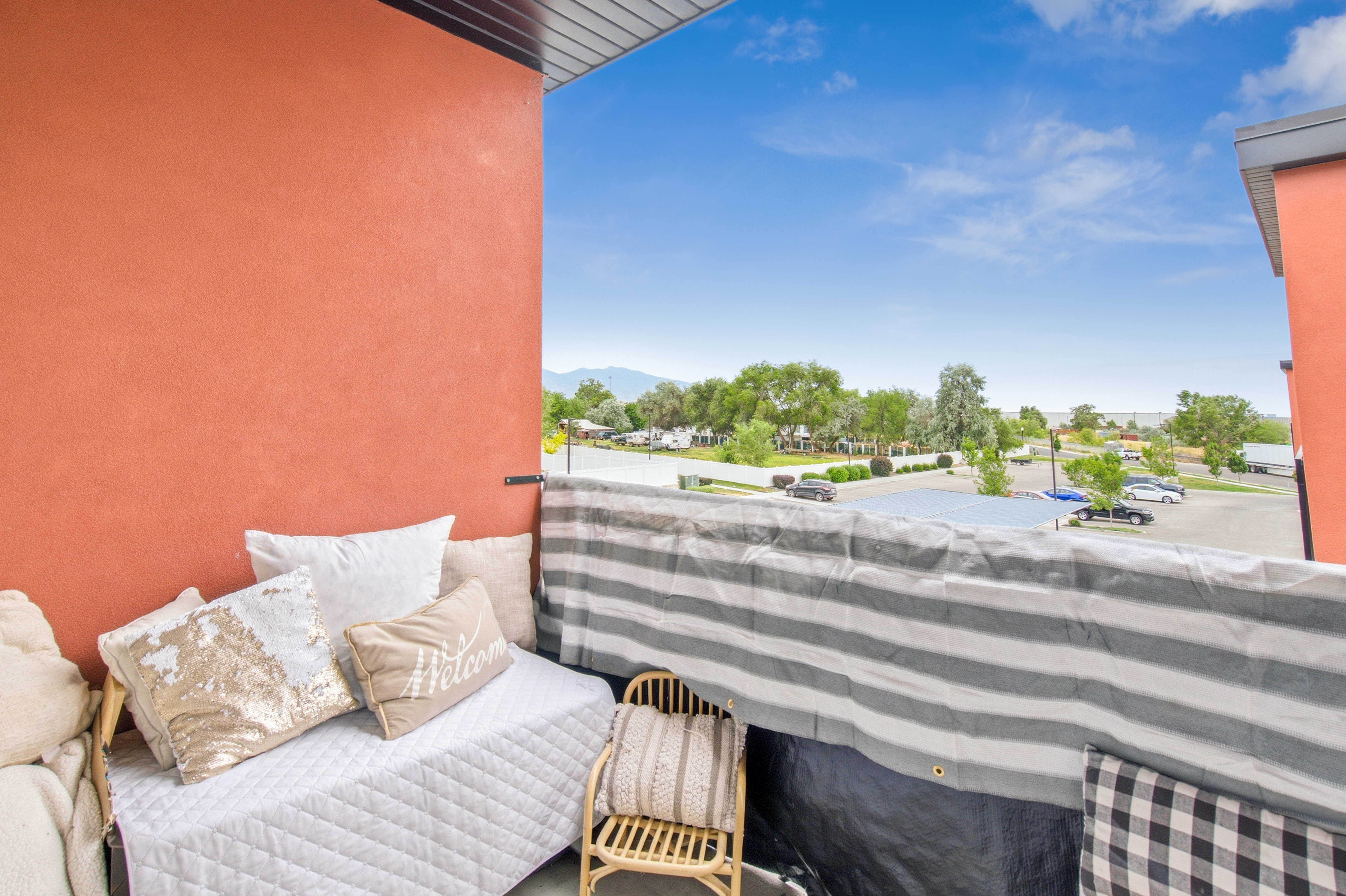 Balcony featuring a terracotta-colored wall and dark soffit