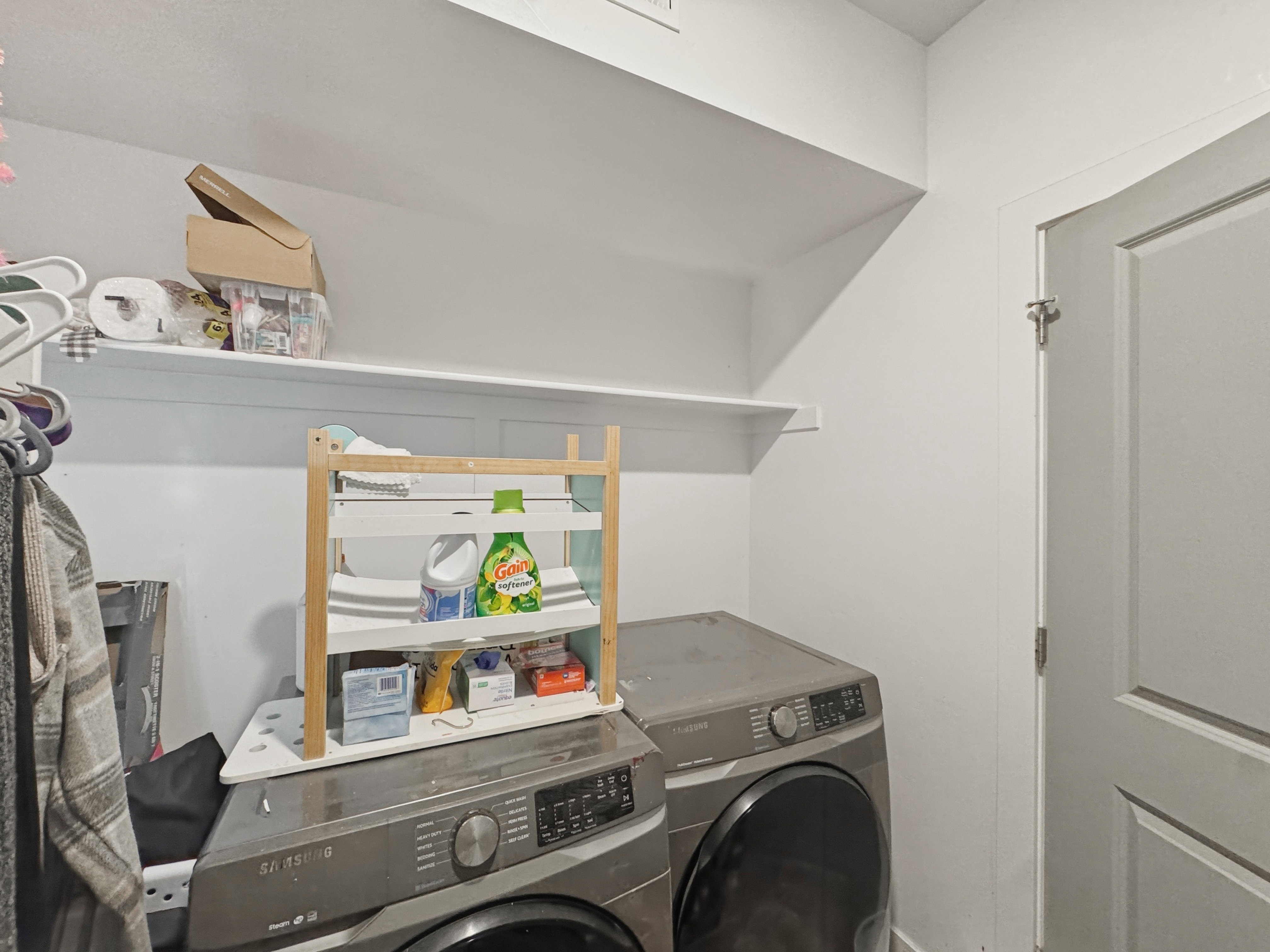 Dedicated laundry area featuring white shelving