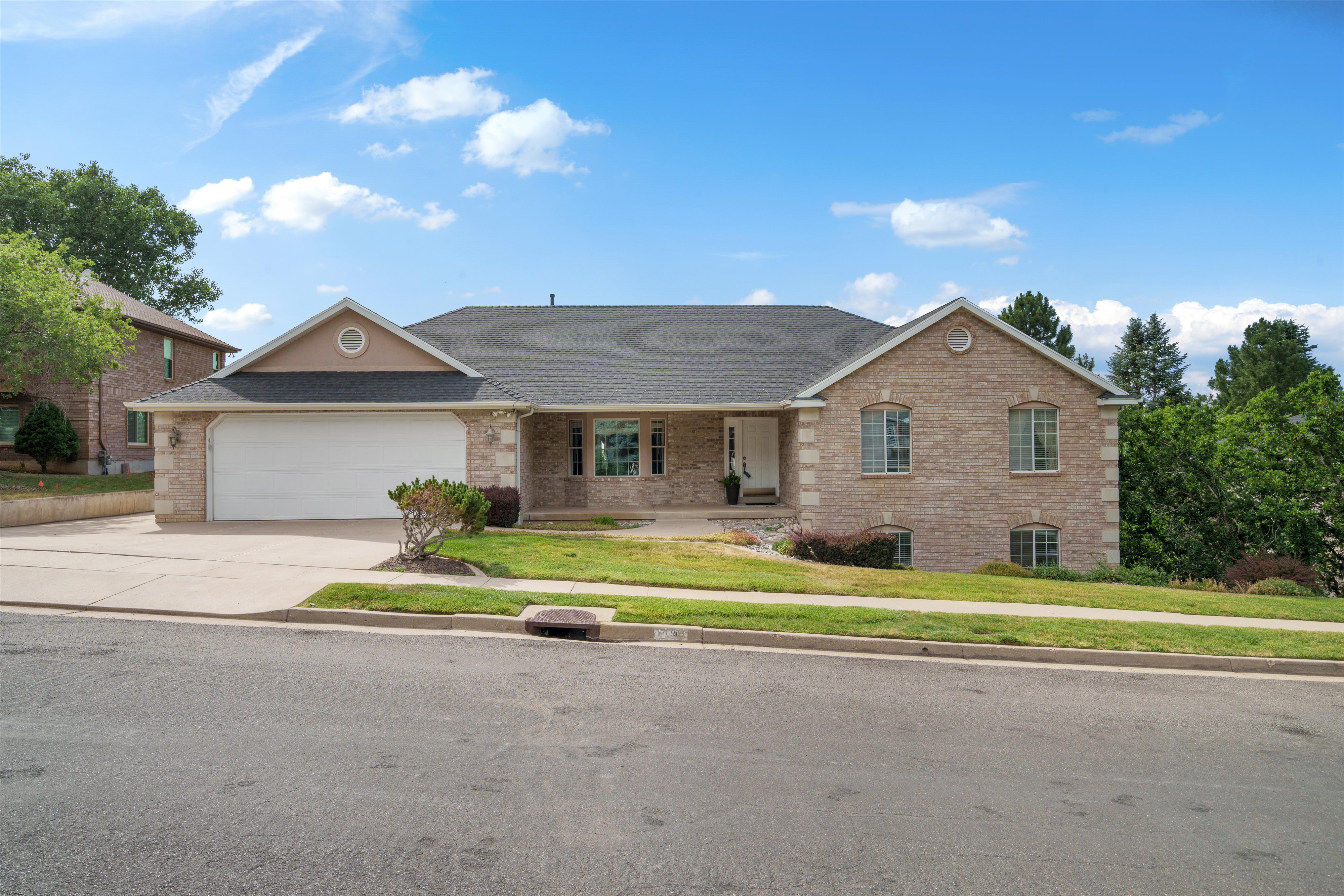 Brick exterior with contrasting stone quoins and a dark shingle roof