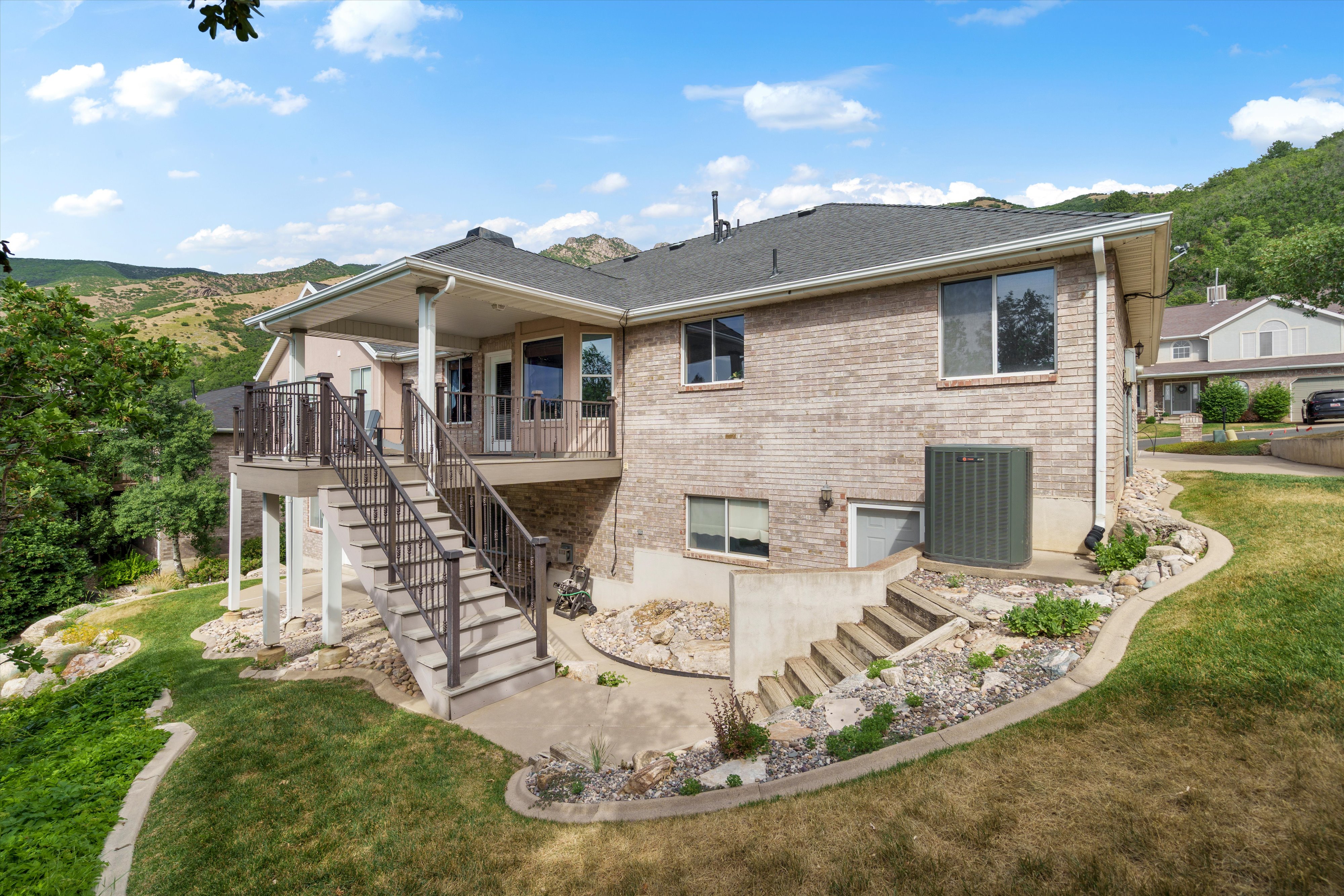 Elevated rear deck with dark railing and stairs leading to the lower level
