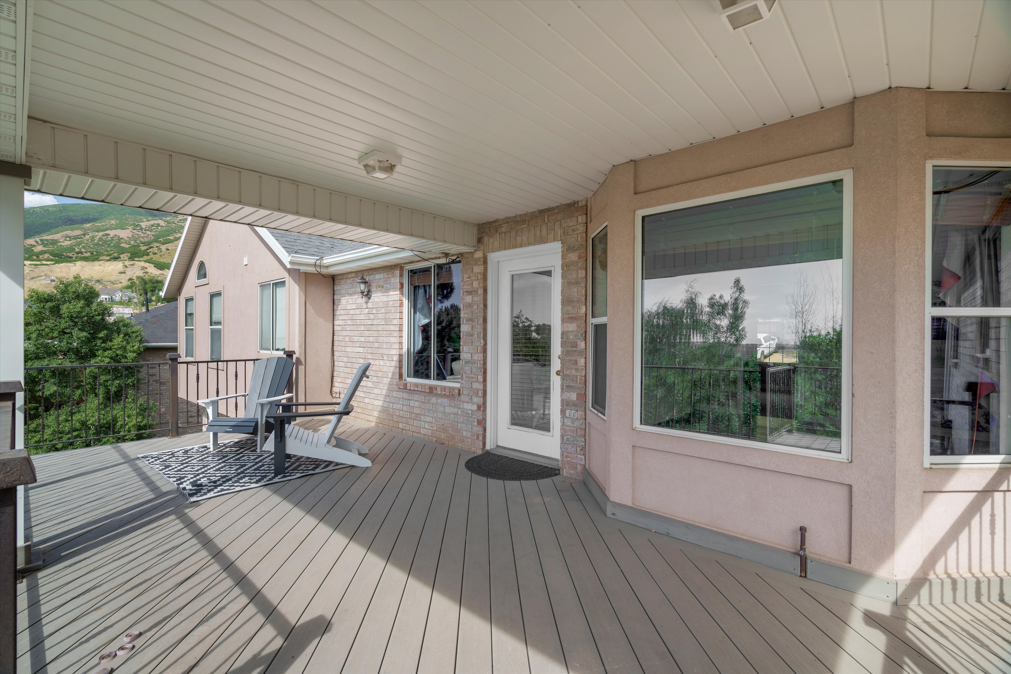 Covered outdoor deck with wood-finish flooring