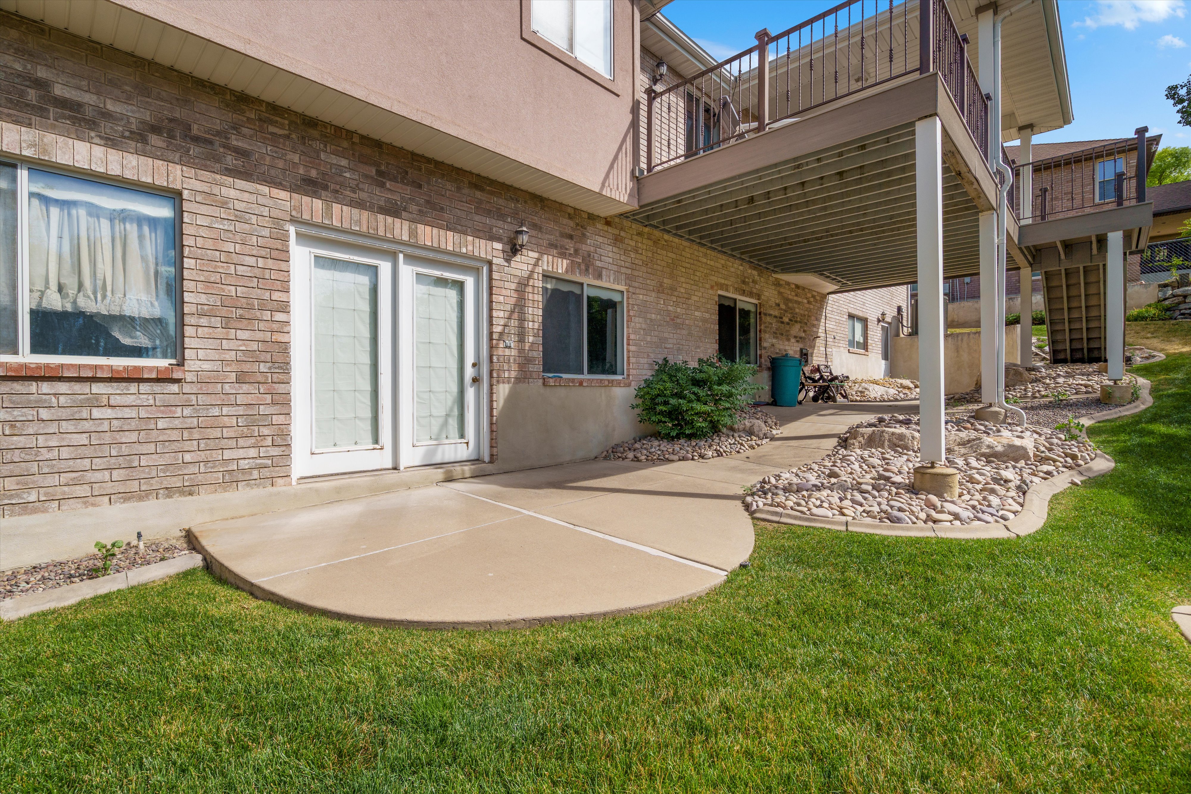 Lower-level patio with brick siding and direct outdoor access