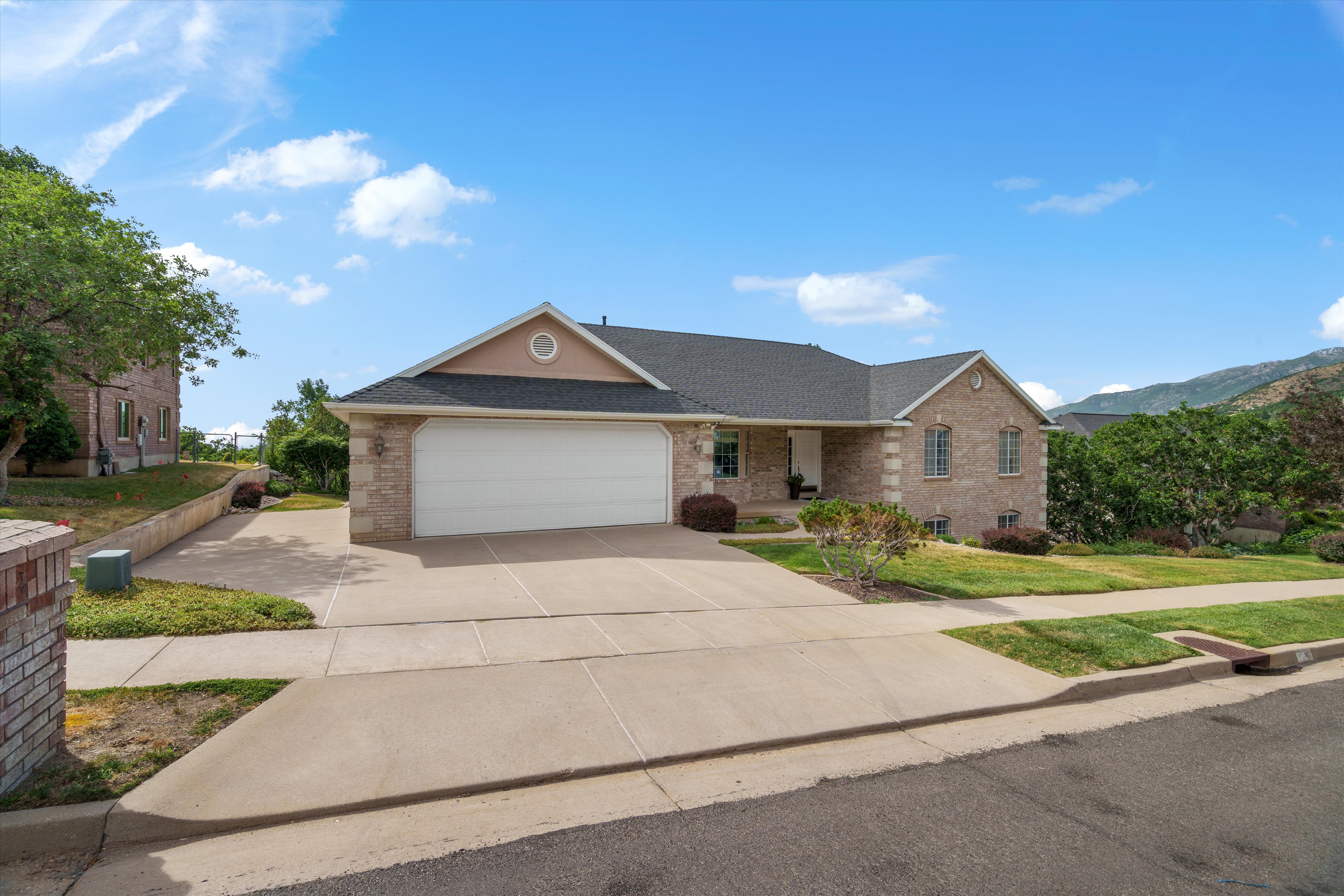 Brick and stone-veneer exterior with a prominent two-car garage