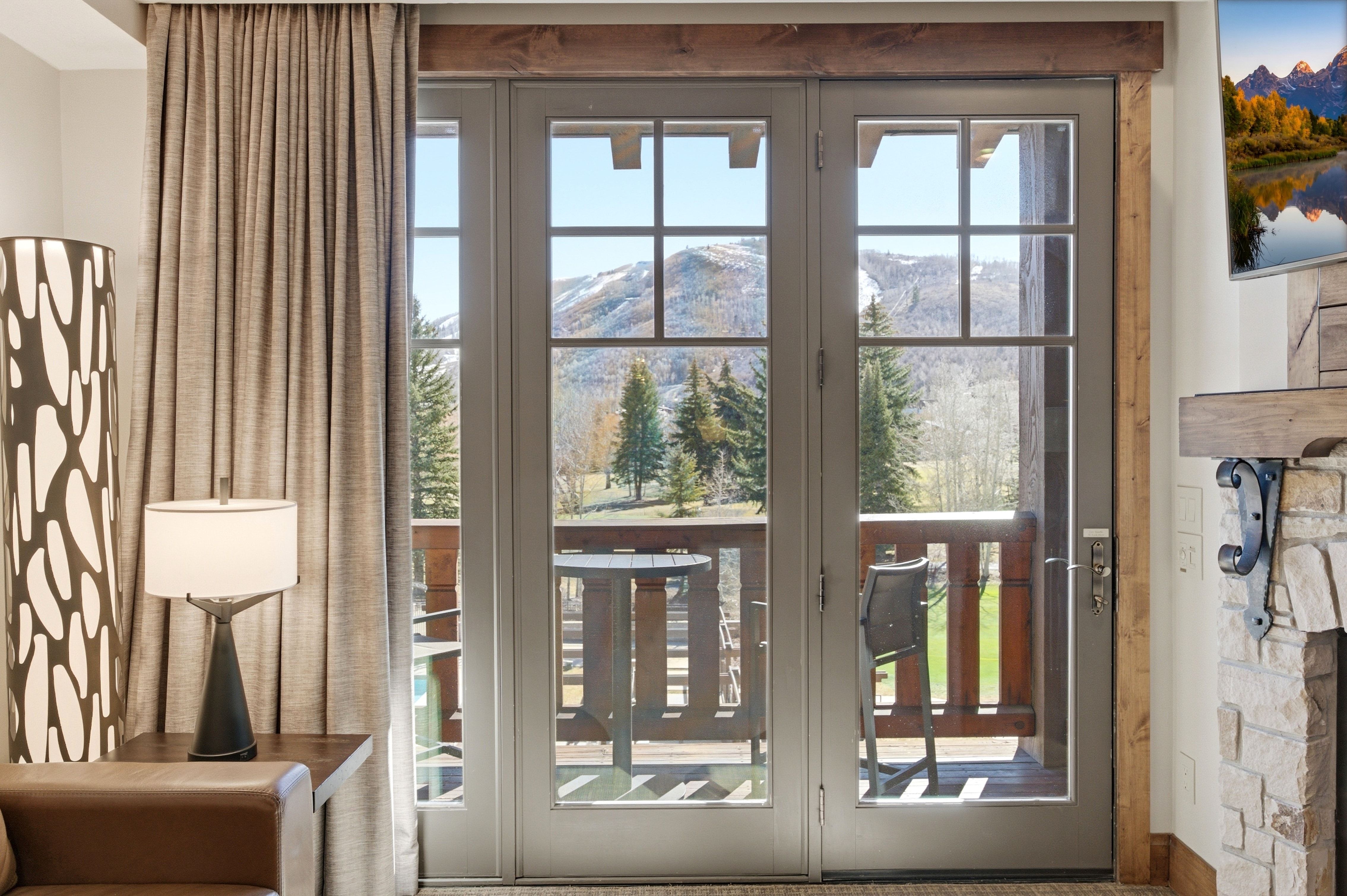 Triple French doors opening to a private balcony