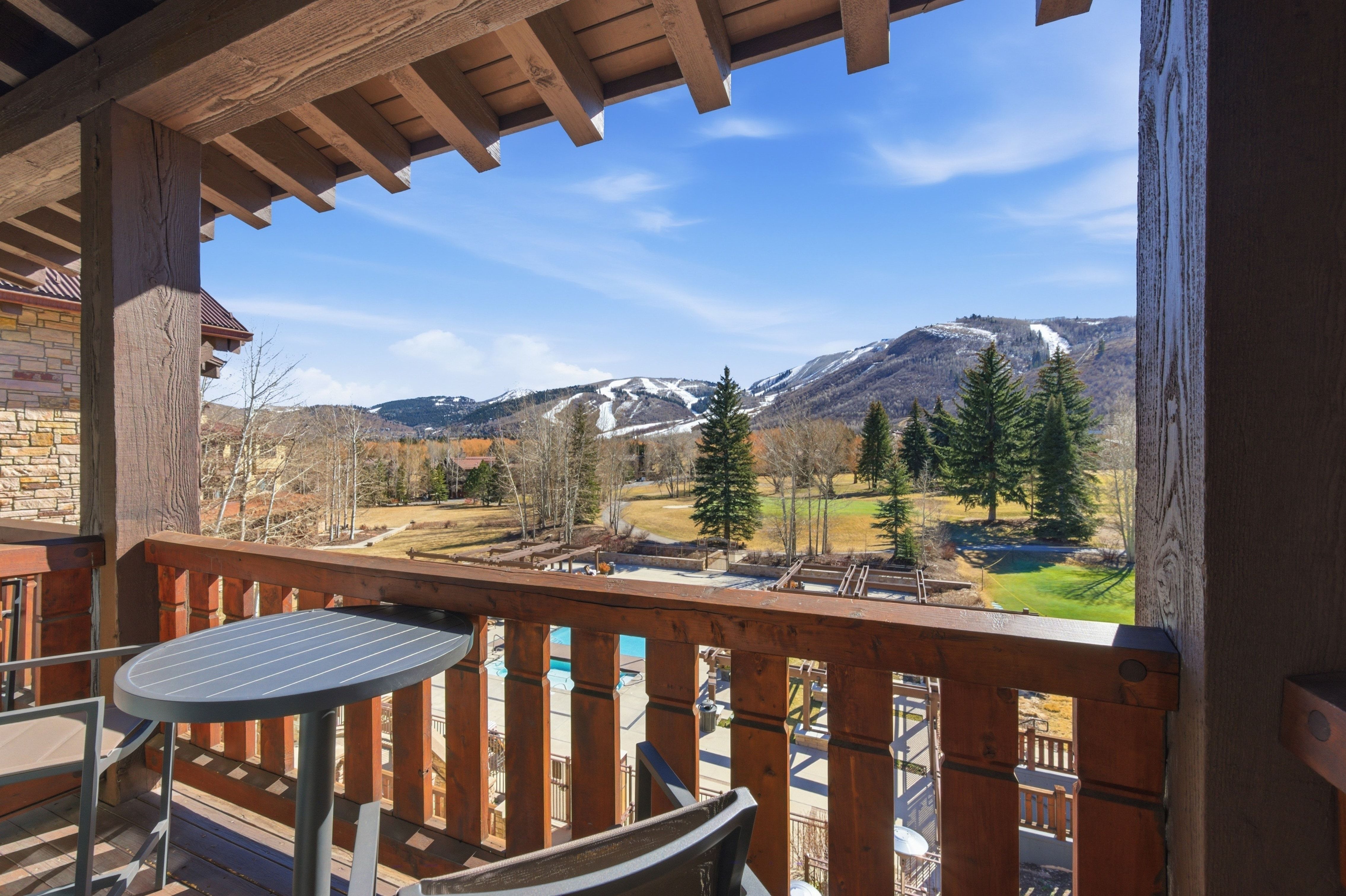 Expansive balcony with wood-finish railings and an overhead pergola structure