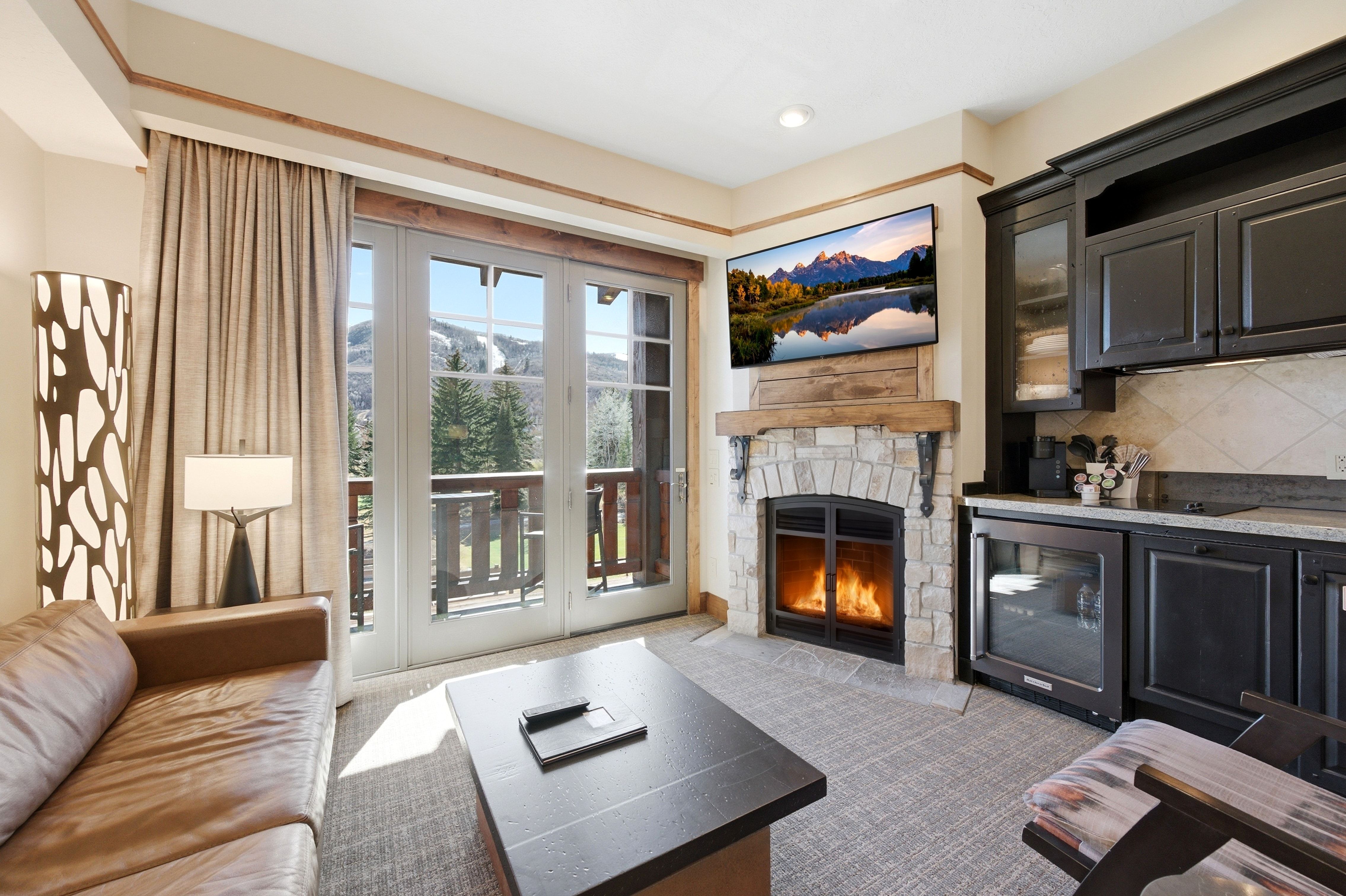 Stone-surround fireplace with a rustic wood mantel