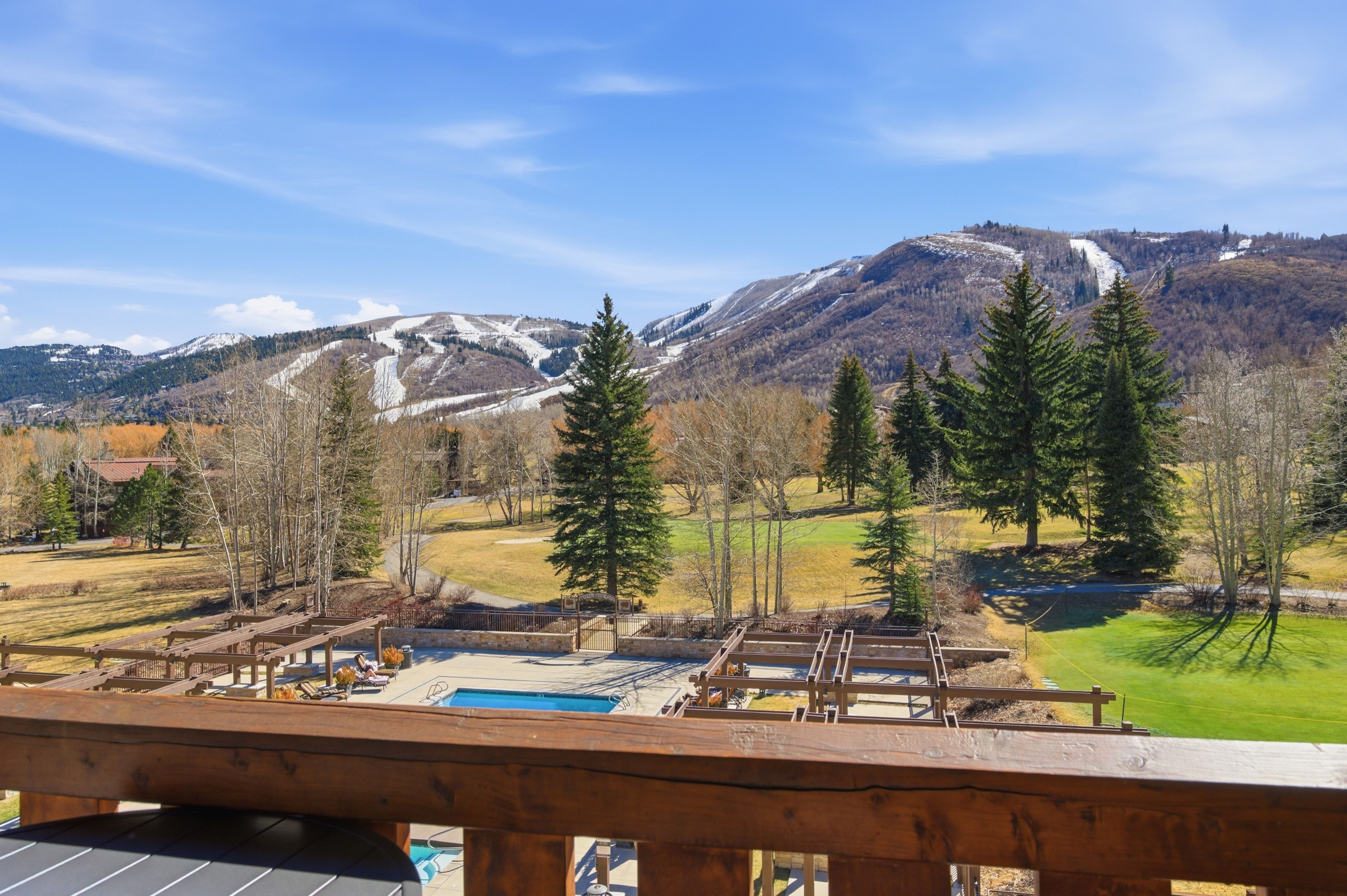 Expansive mountain scenery featuring snow-dusted peaks and evergreen trees