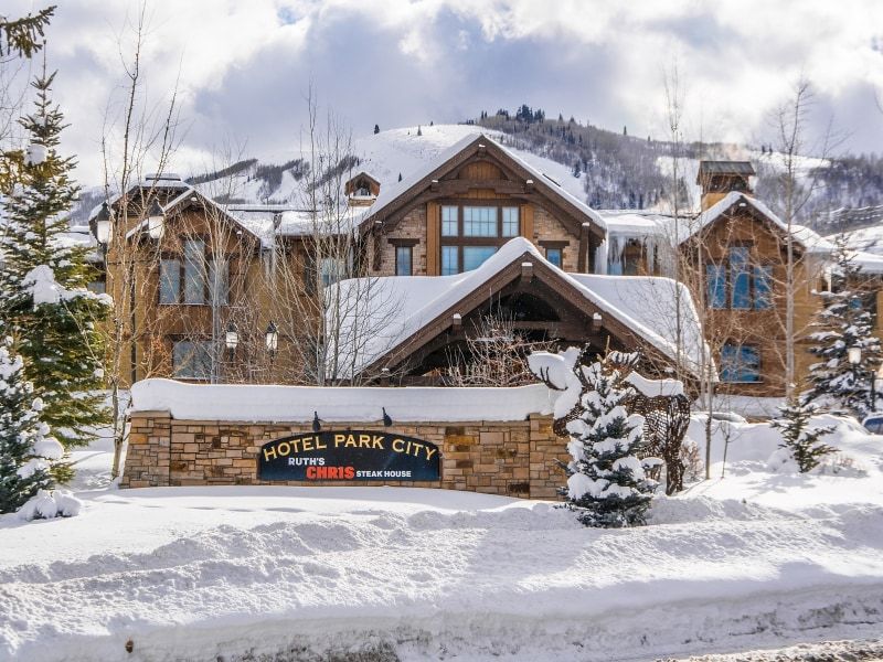Stone and timber lodge-style architecture featuring multiple gables and a prominent entry