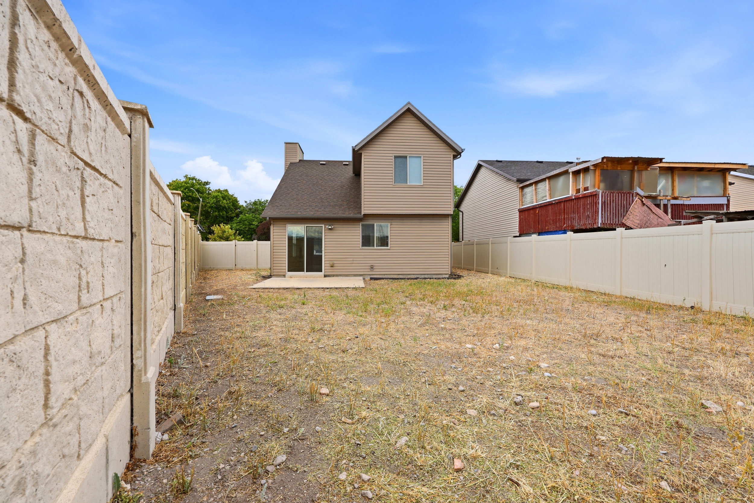 Expansive backyard with a two-story residence featuring siding and a shingled roof