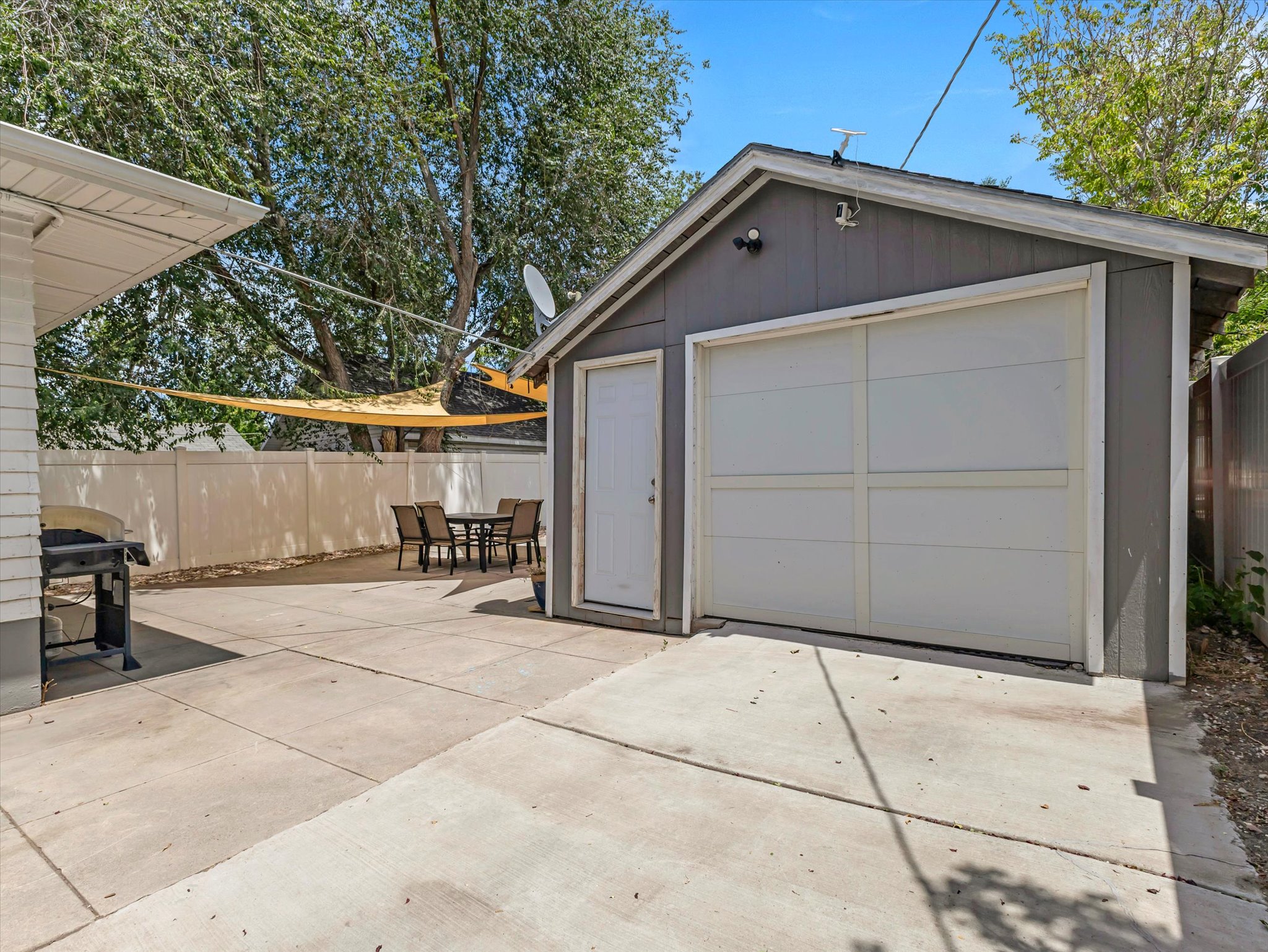 Detached garage with a paneled door and a separate entry door