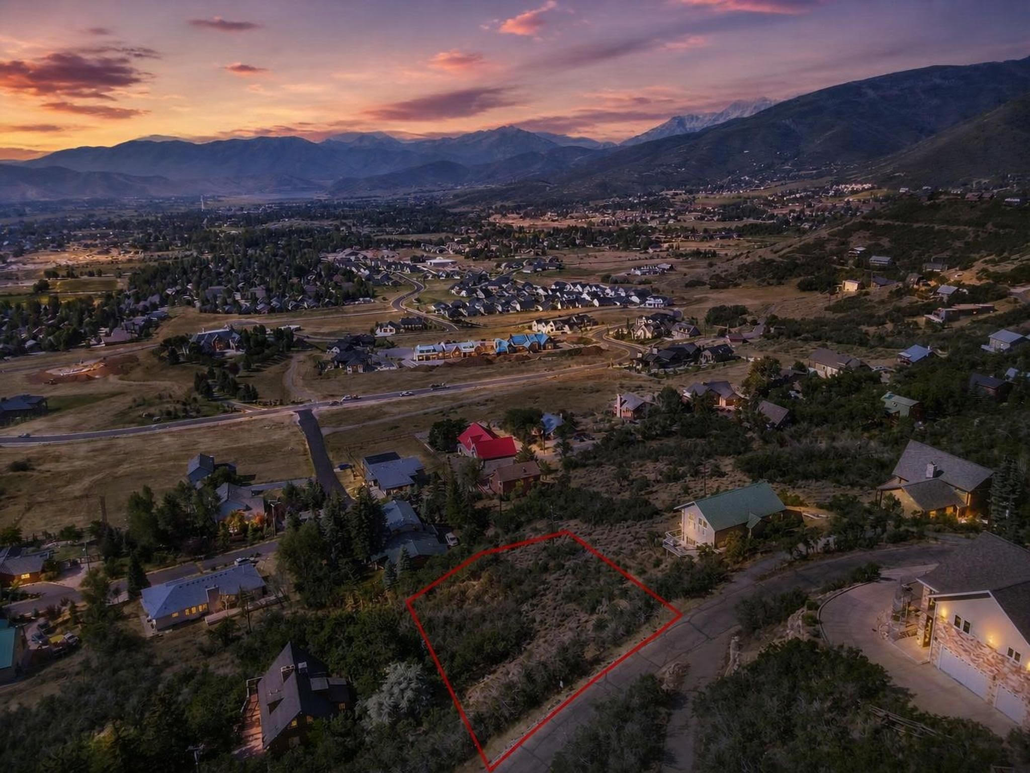 Expansive undeveloped land parcel outlined in red, featuring natural vegetation and a gentle slope