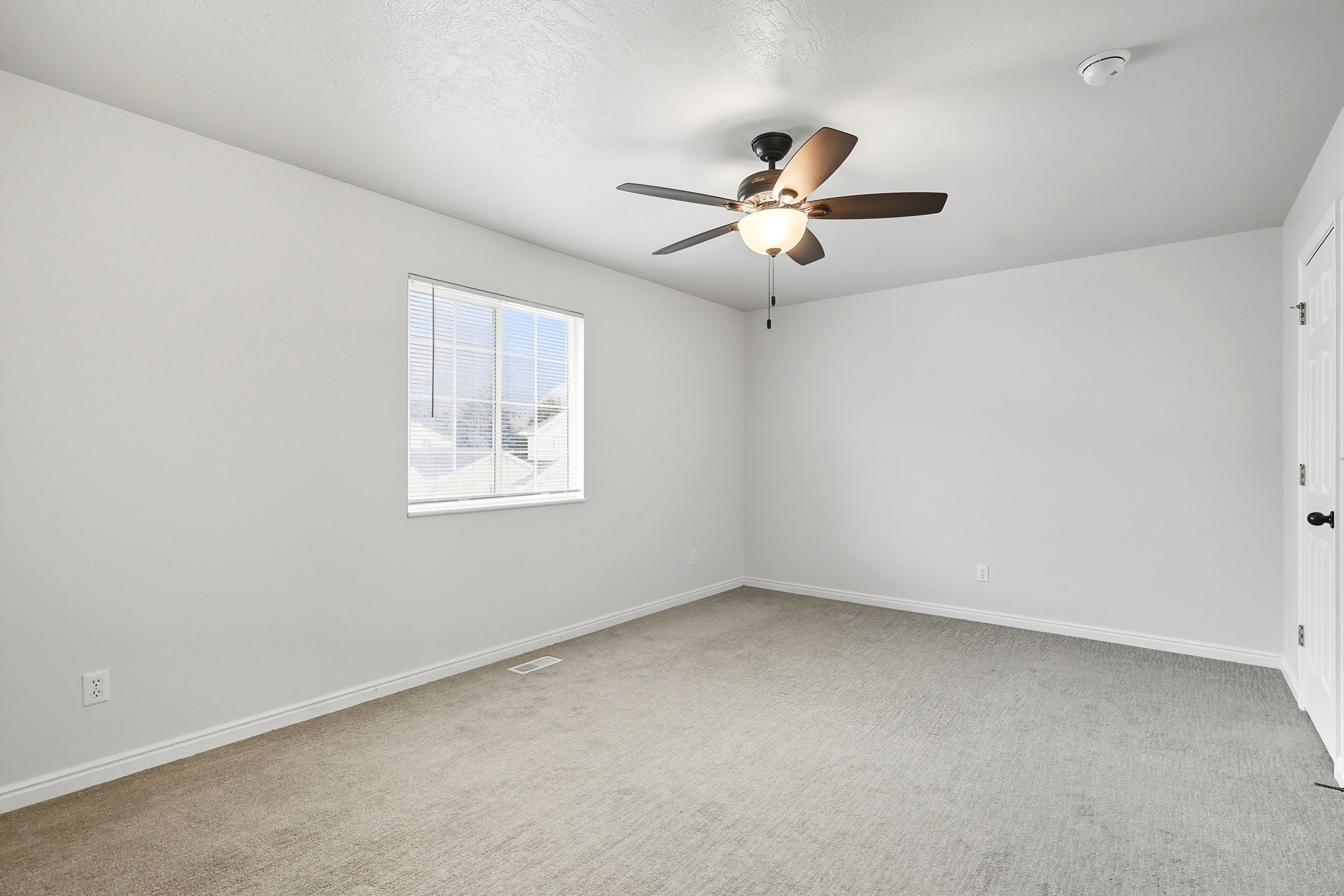 bedroom with door to shared full bathroom