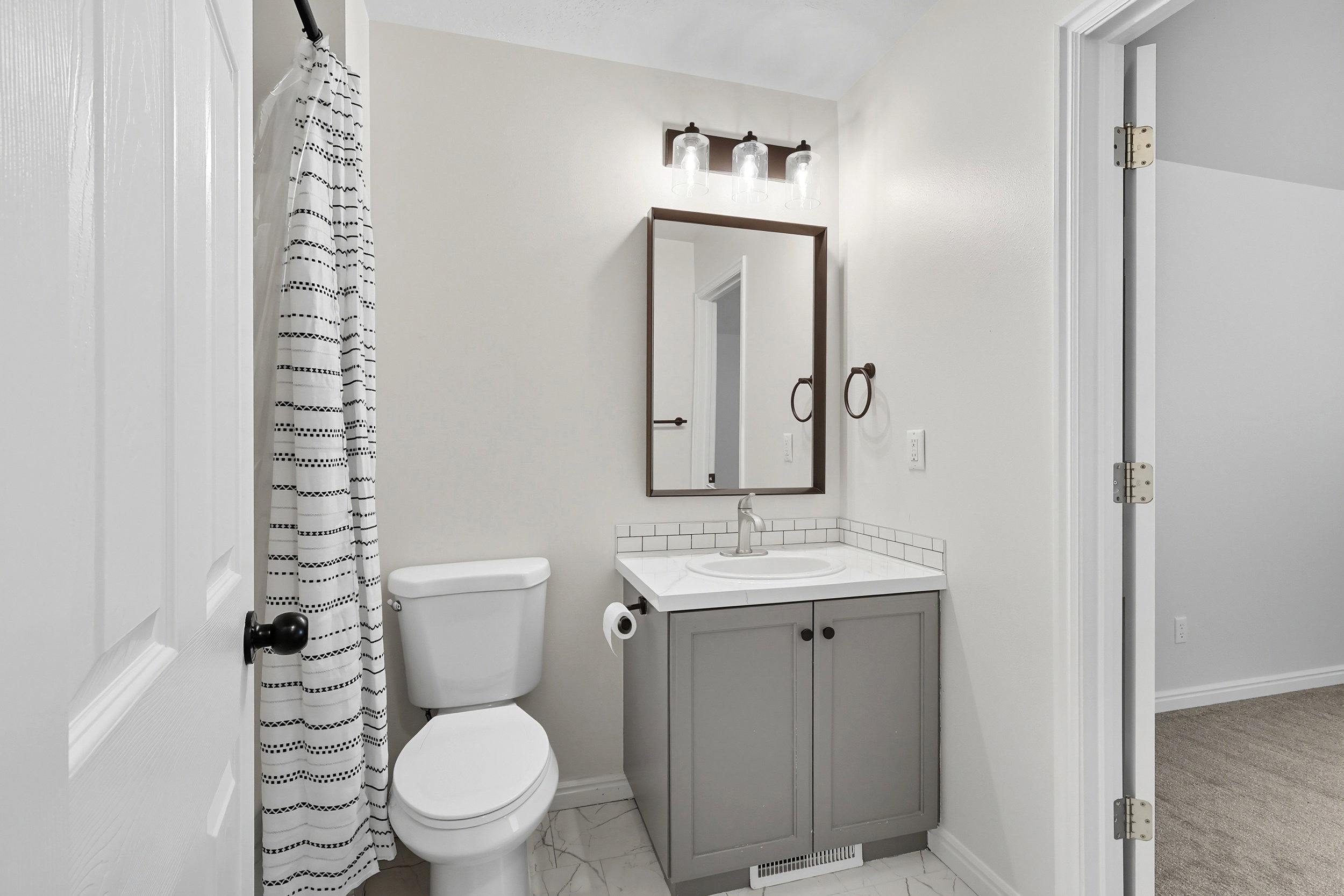 bathroom has door into one bedroom and door into the hallway