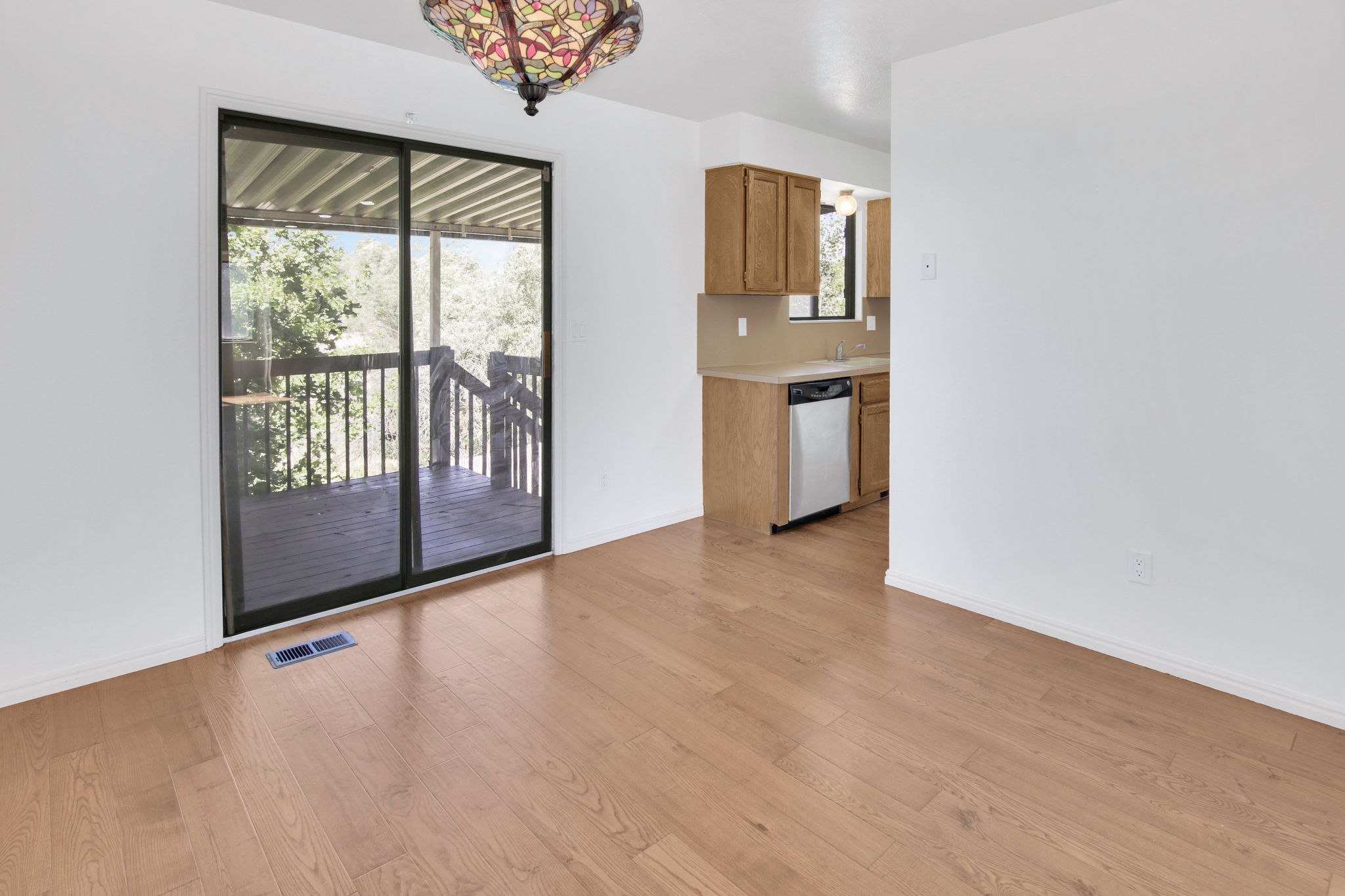 Bright interior with wood-finish flooring and a decorative ceiling fixture