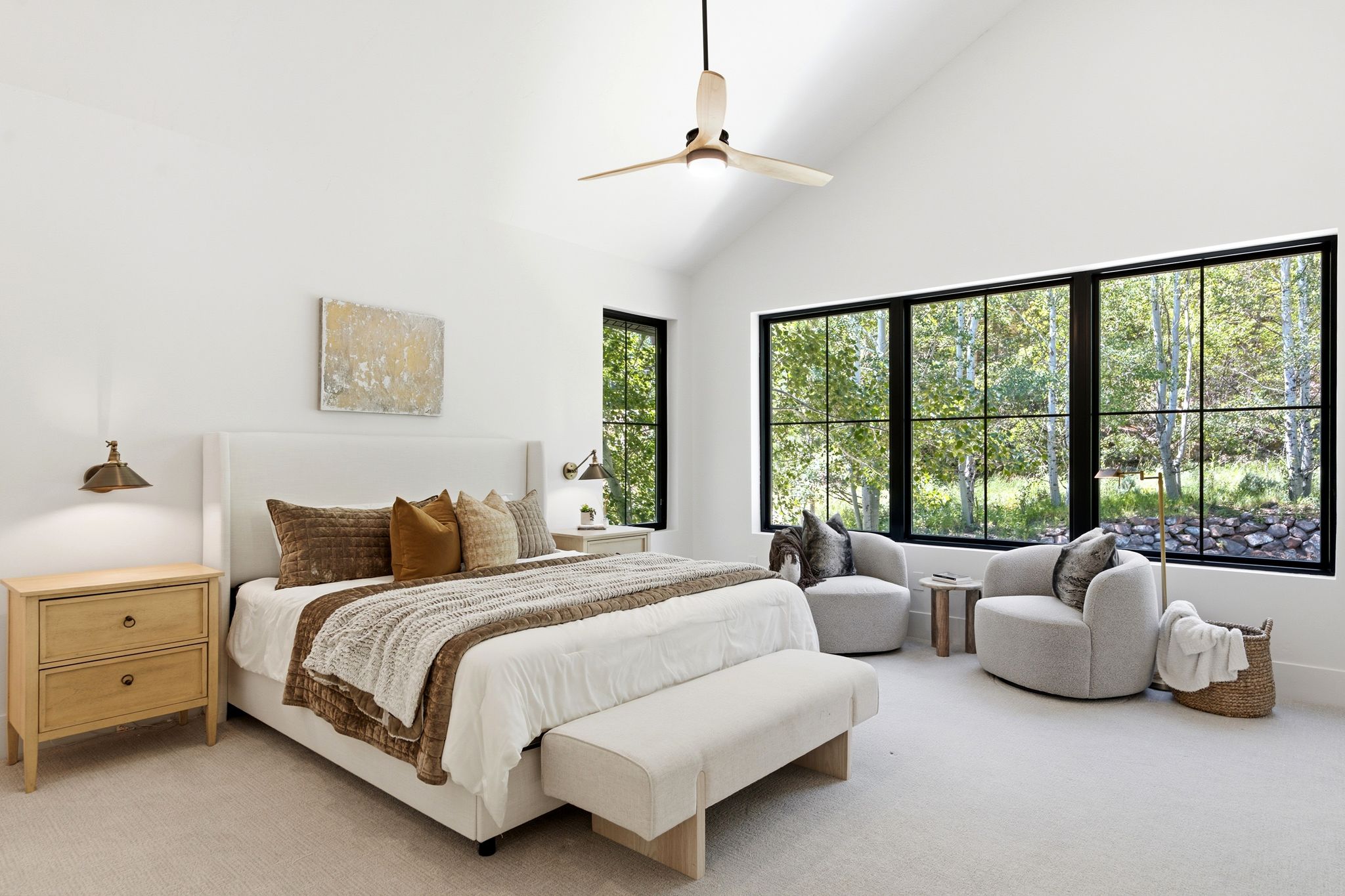 Bedroom featuring vaulted ceilings, a contemporary ceiling fan, and large black-framed windows
