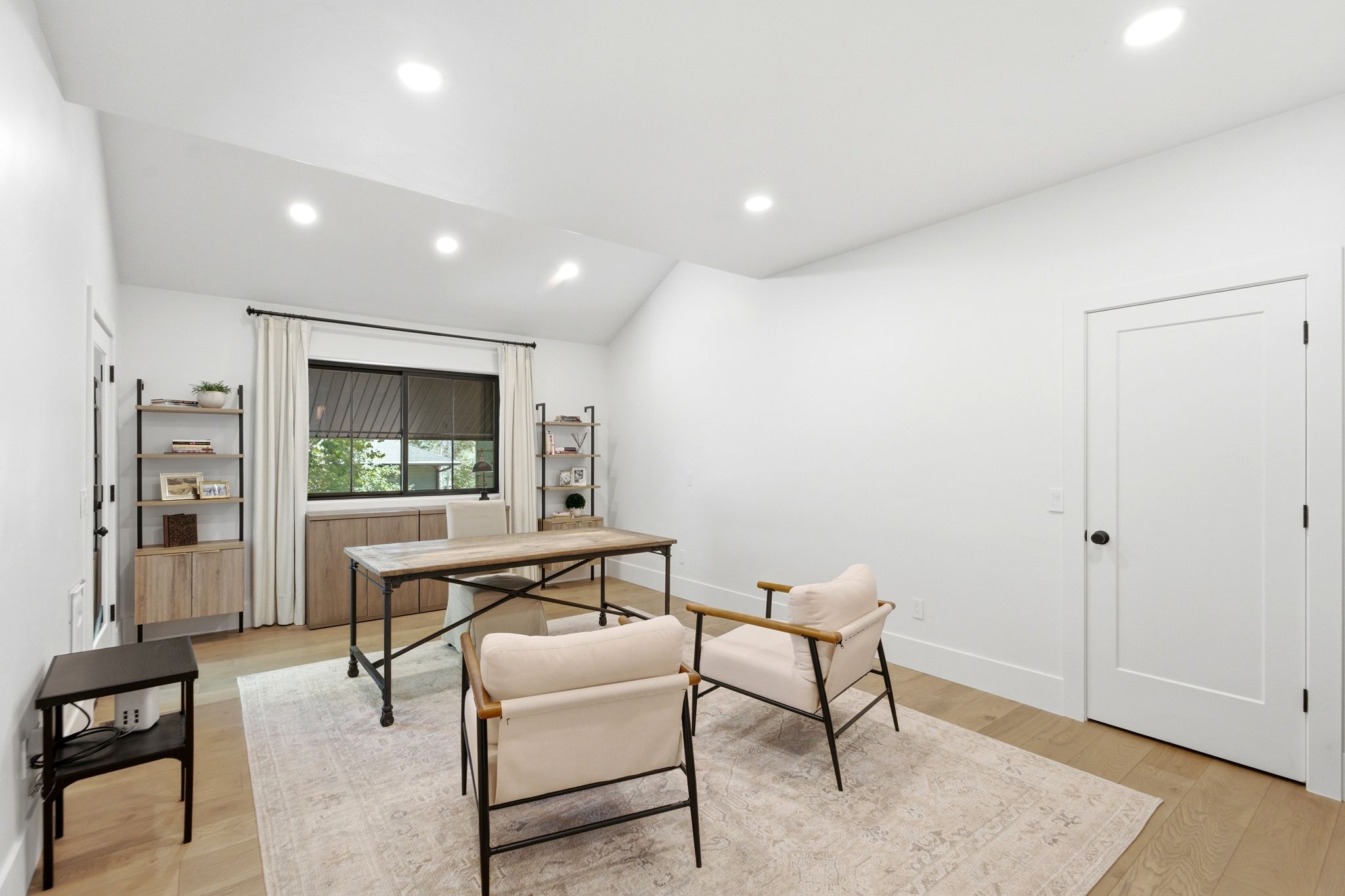 Vaulted ceiling room featuring recessed lighting, wood-finish flooring, and white walls