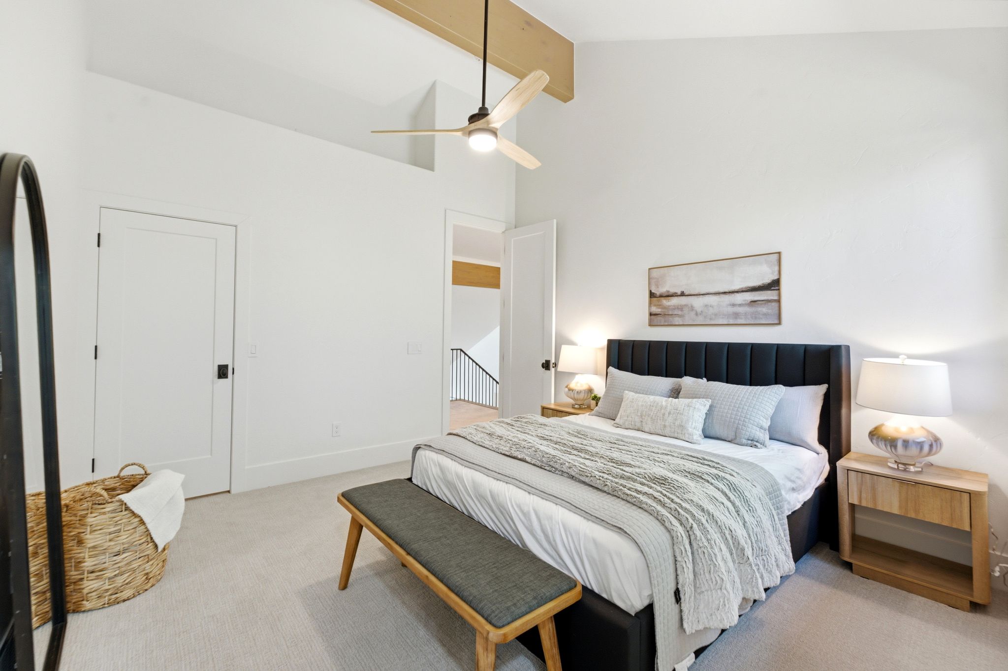 Vaulted ceiling featuring a natural wood beam and ceiling fan