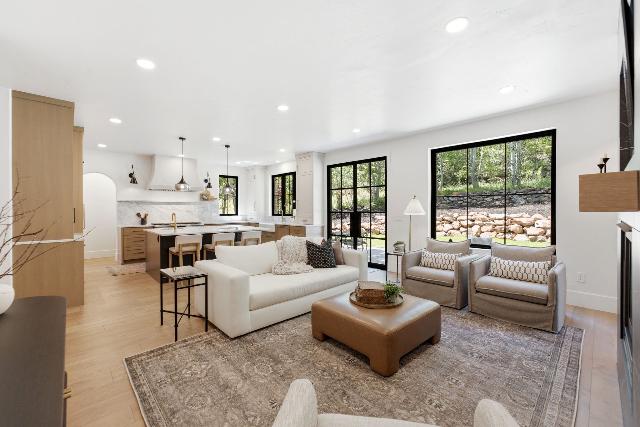 Open-concept living space featuring wood-finish flooring and recessed lighting