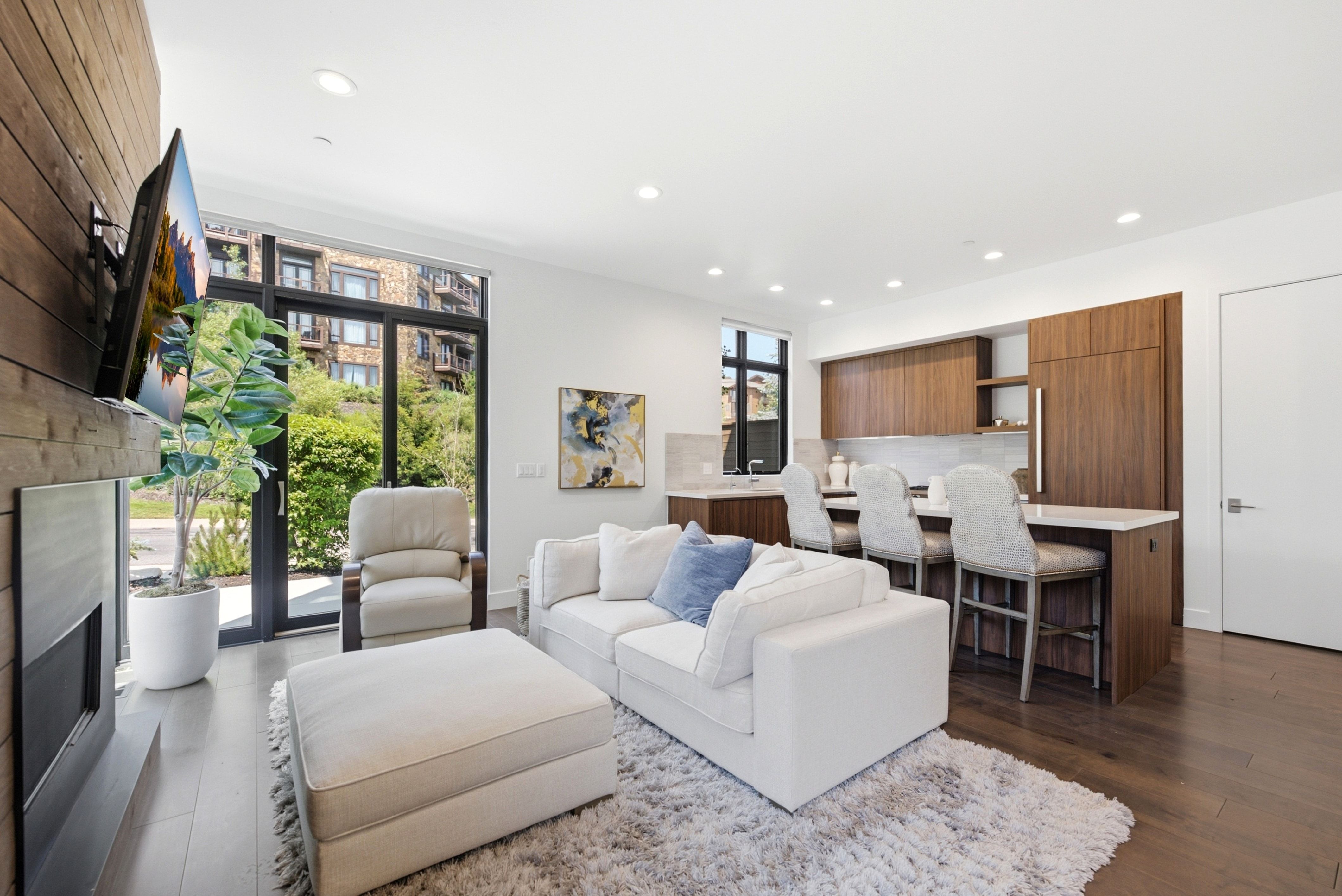 Open-concept living space featuring wood-finish flooring and recessed lighting