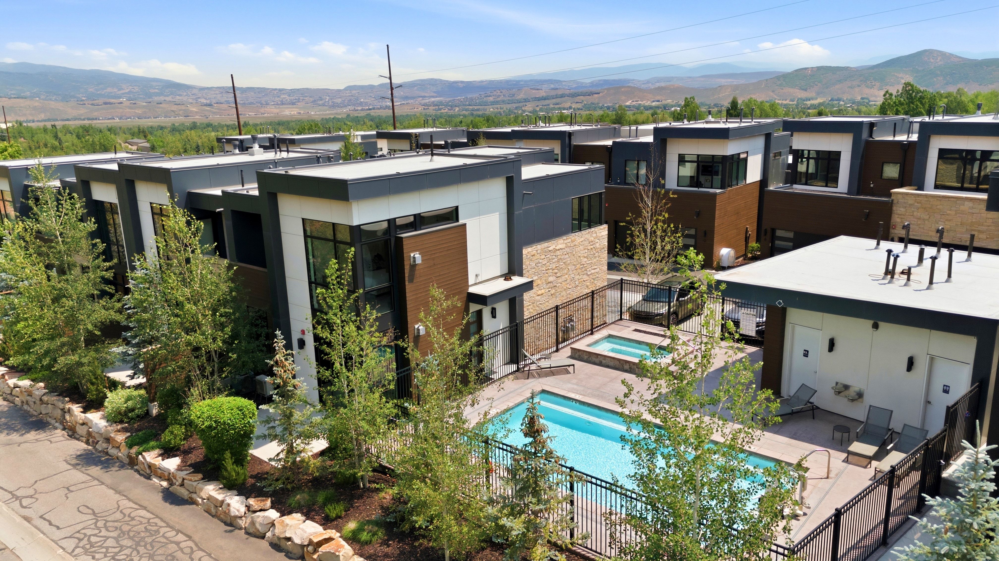 Modern townhome community featuring contemporary architecture with white and wood-finish siding accents