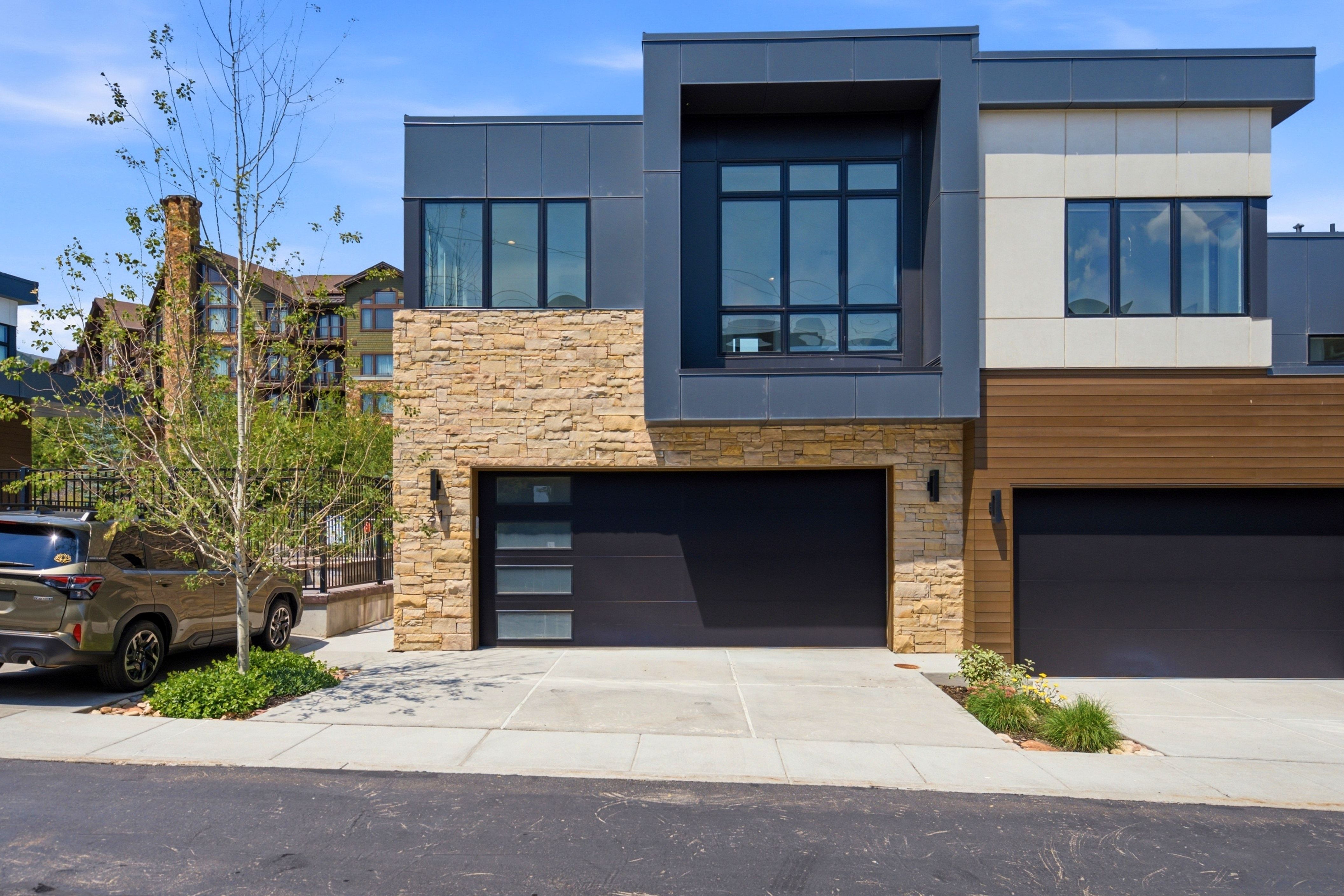 Contemporary exterior featuring a stone and panel facade