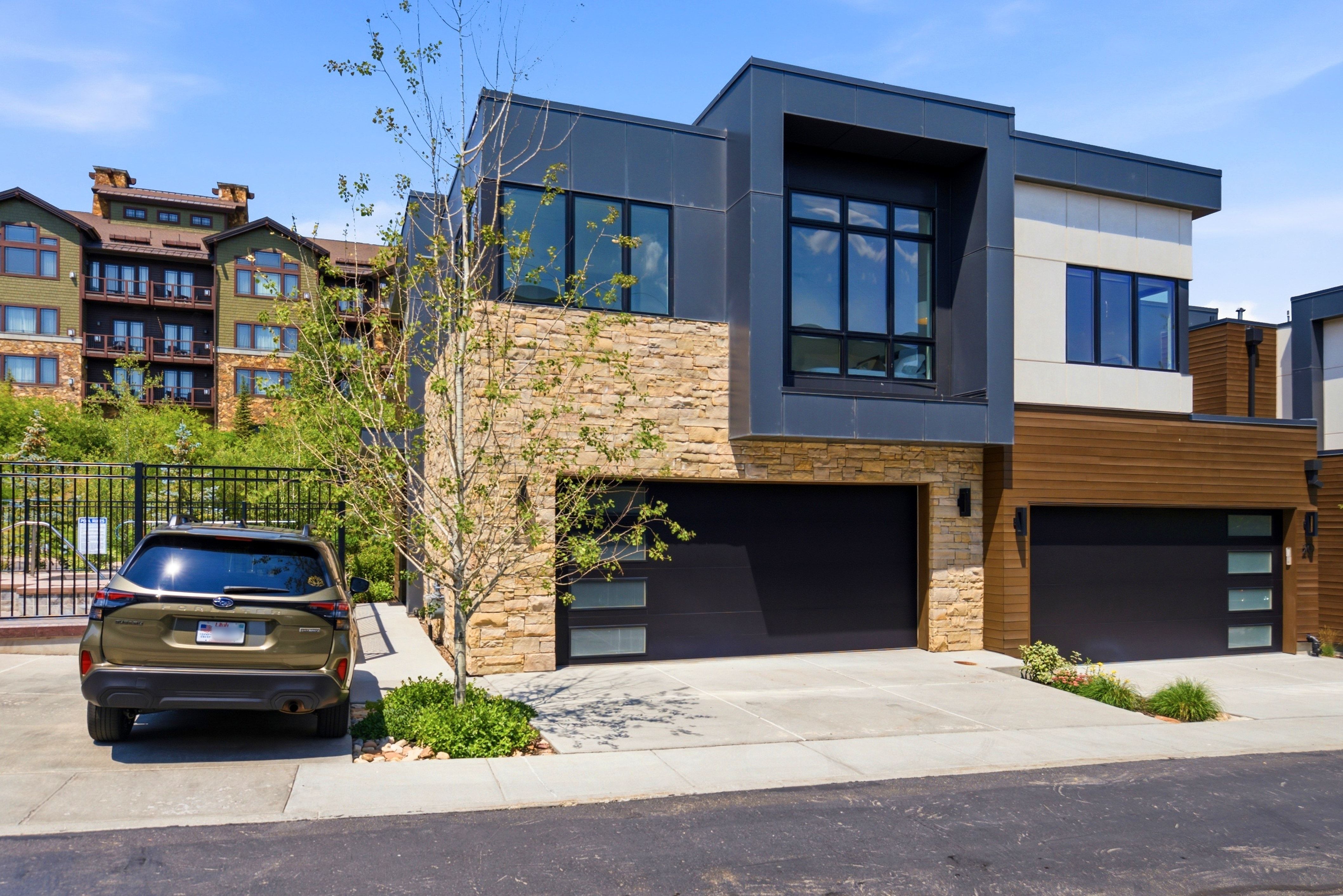 Modern architectural style featuring stacked stone and dark paneling