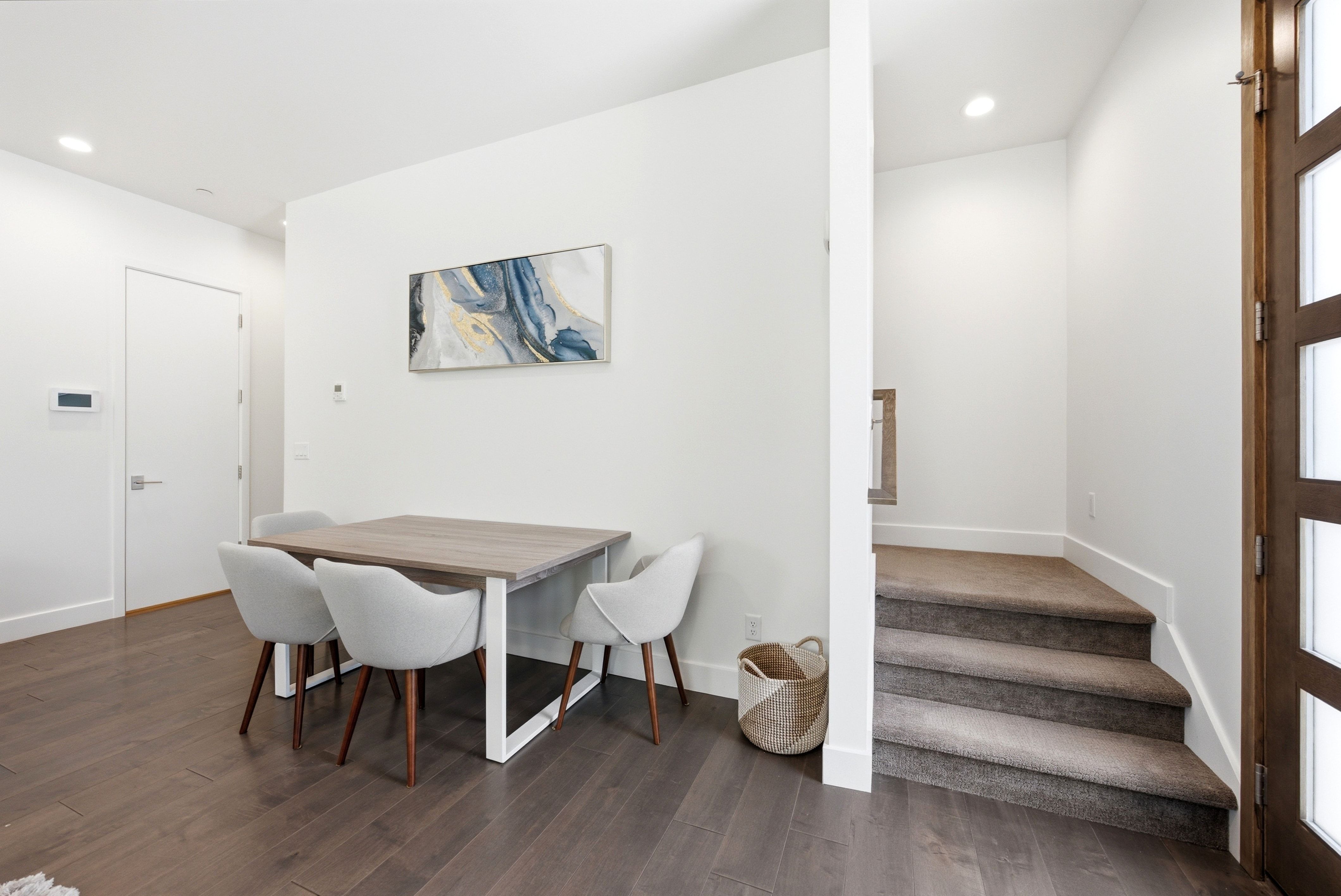 Hardwood-finish flooring extending from the entryway