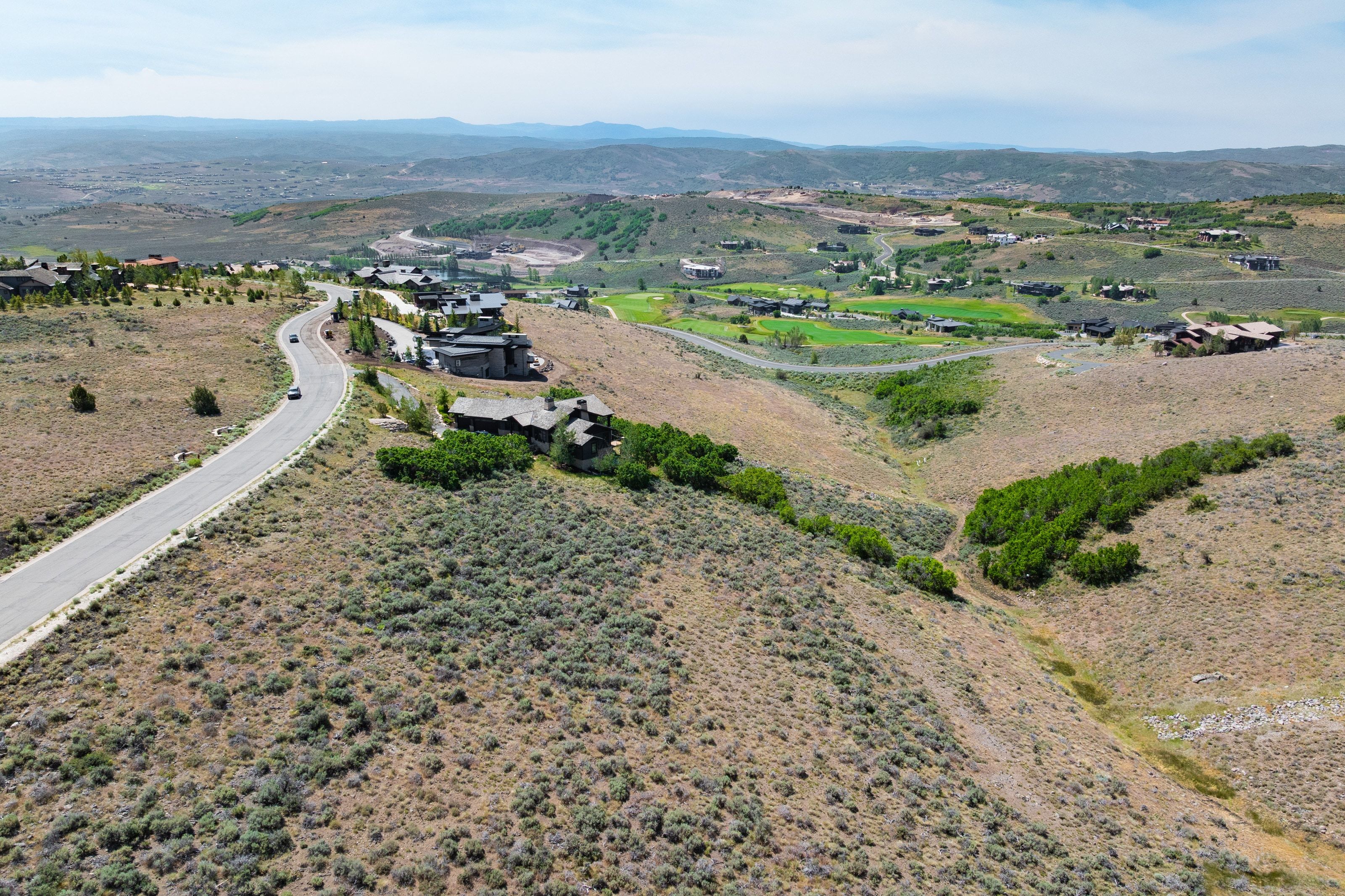 Expansive undeveloped land featuring natural high desert landscaping and distant mountain ranges