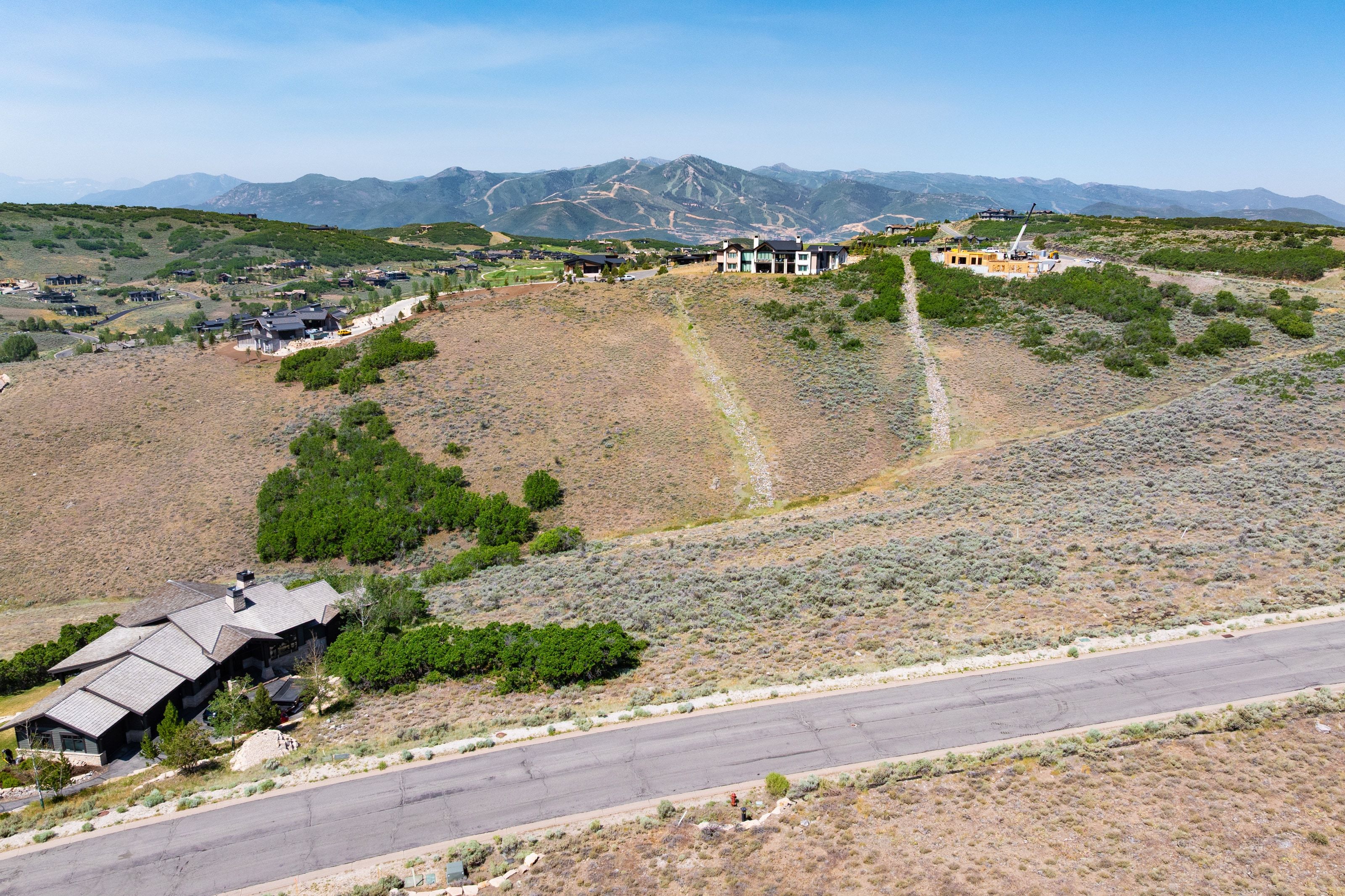 Expansive mountain landscape featuring a paved road