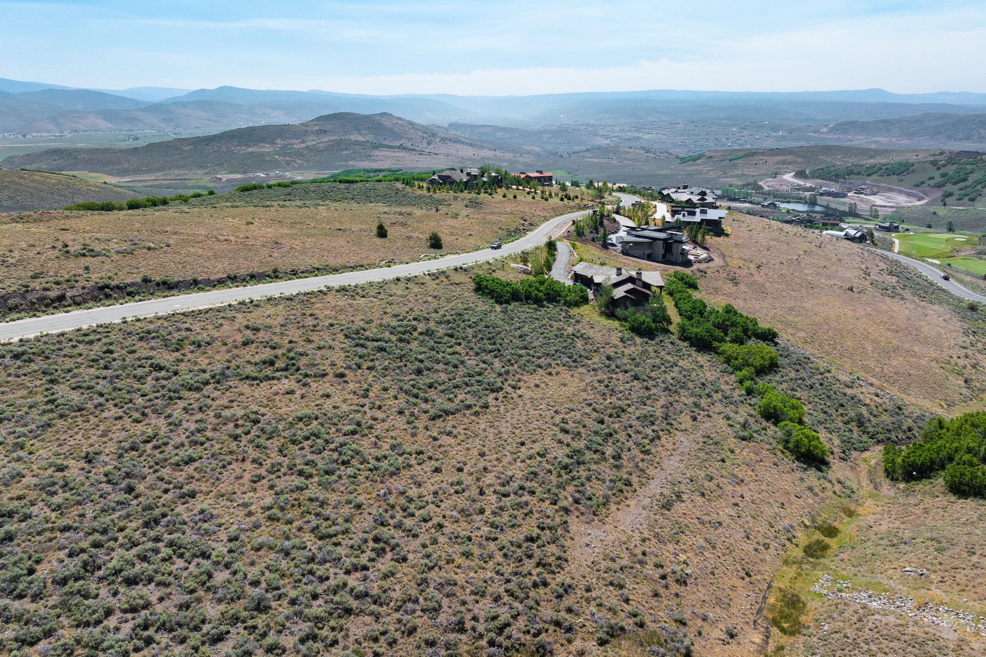 Elevated property featuring expansive open terrain and distant mountain ranges