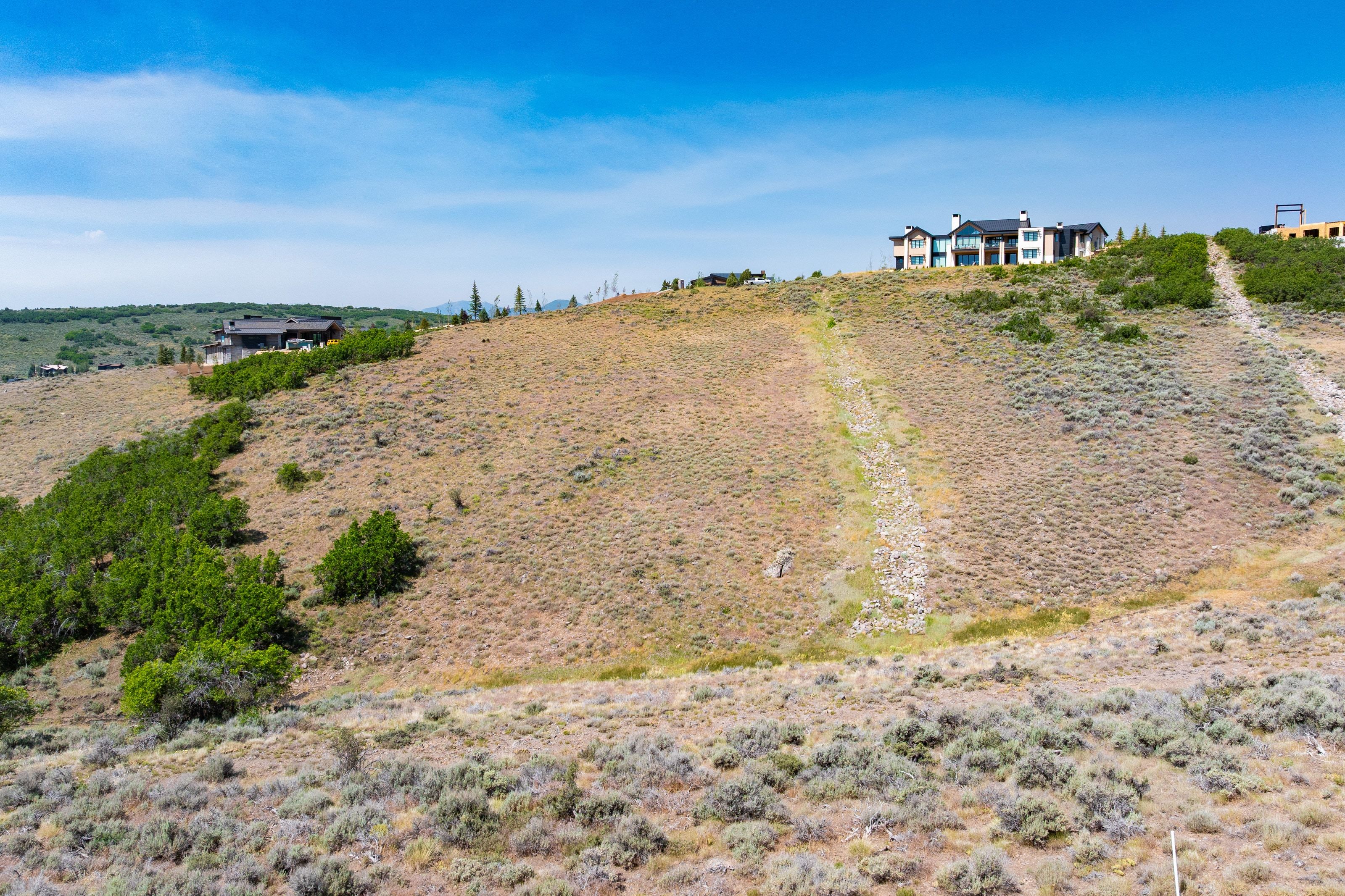 Expansive undeveloped land featuring natural high desert vegetation and varying topography
