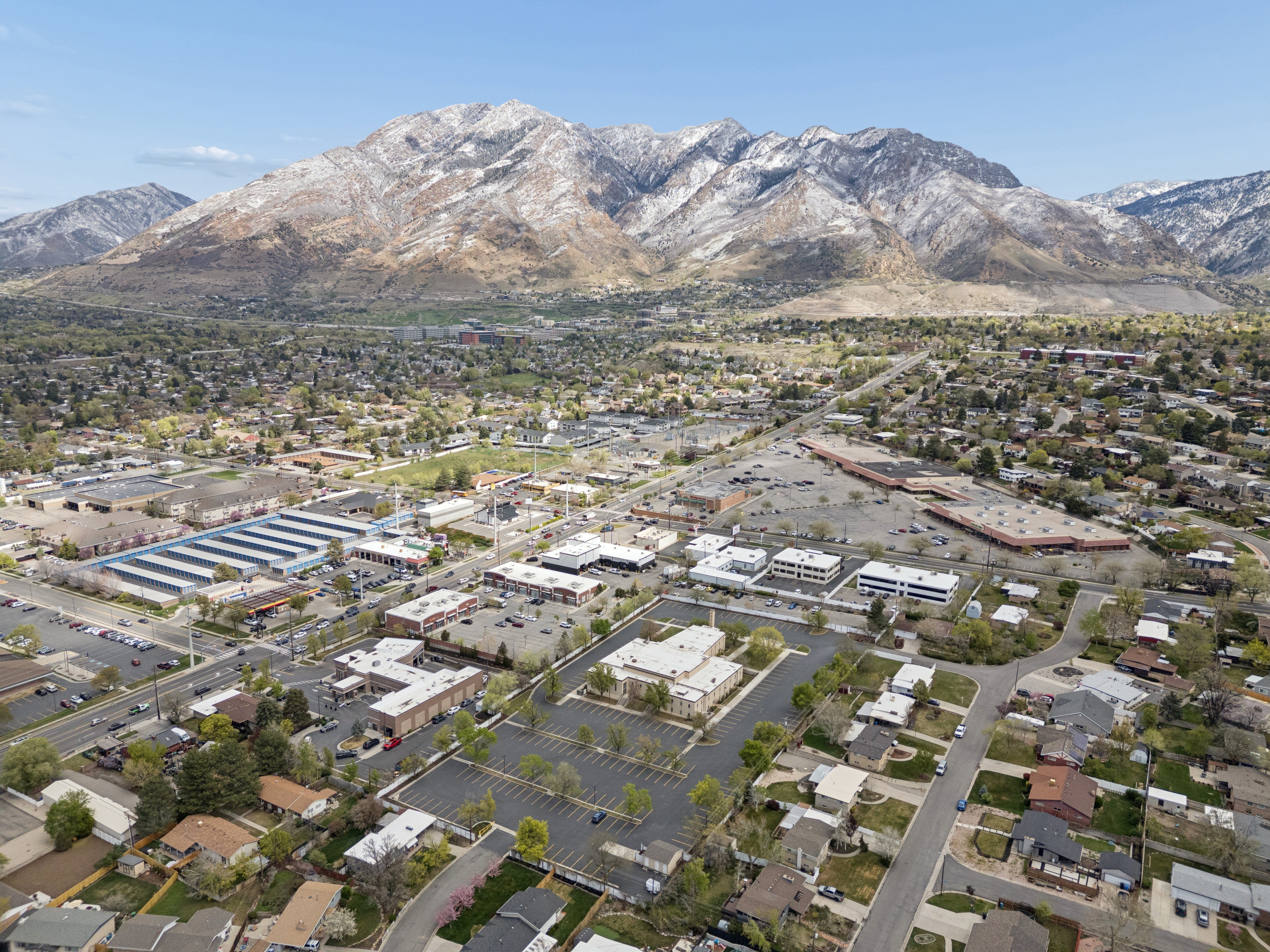 Expansive mountain range backdrop framing a mixed-use neighborhood
