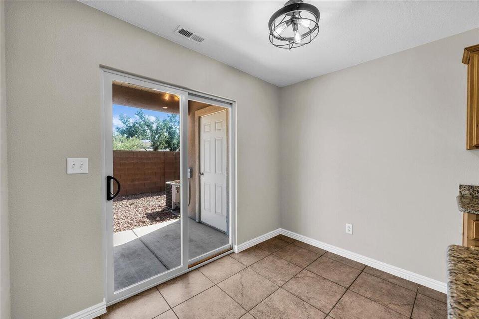 Interior space featuring ceramic tile flooring, neutral wall tones, and a contemporary semi-flush mount light fixture
