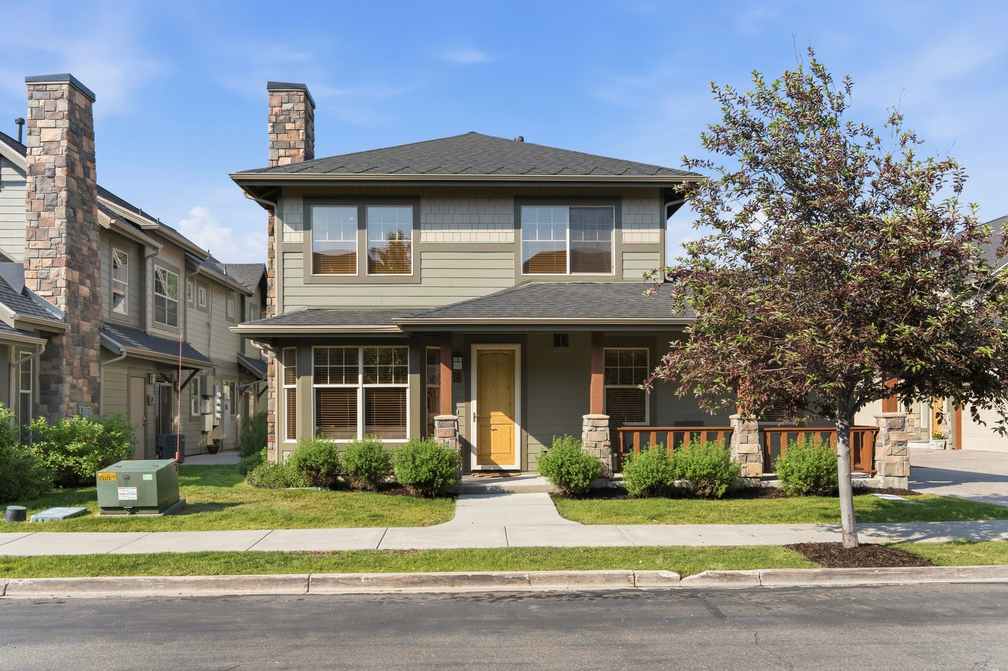 Two-story residence featuring siding and stone exterior accents