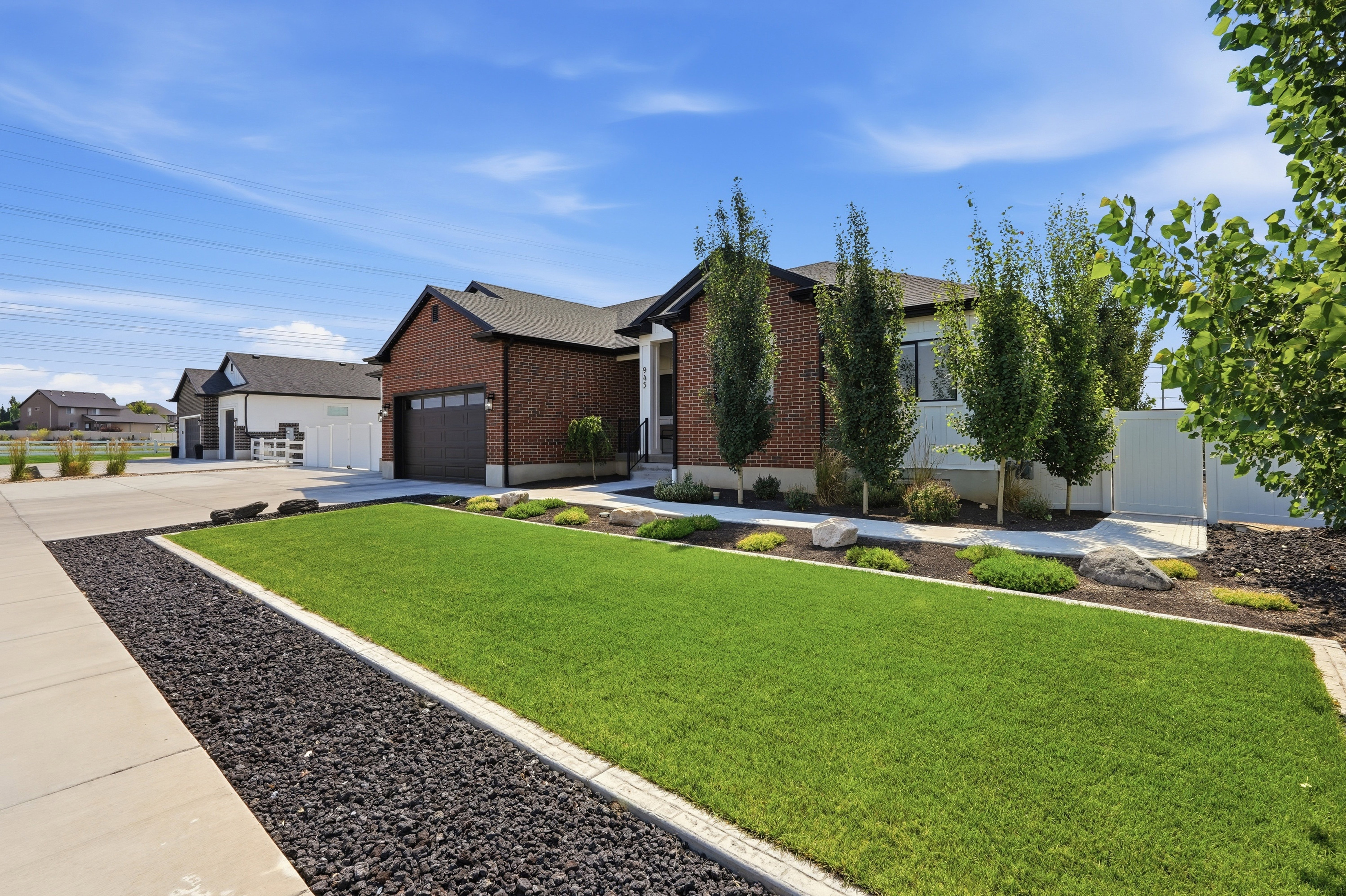 Contemporary residence featuring brick and white siding