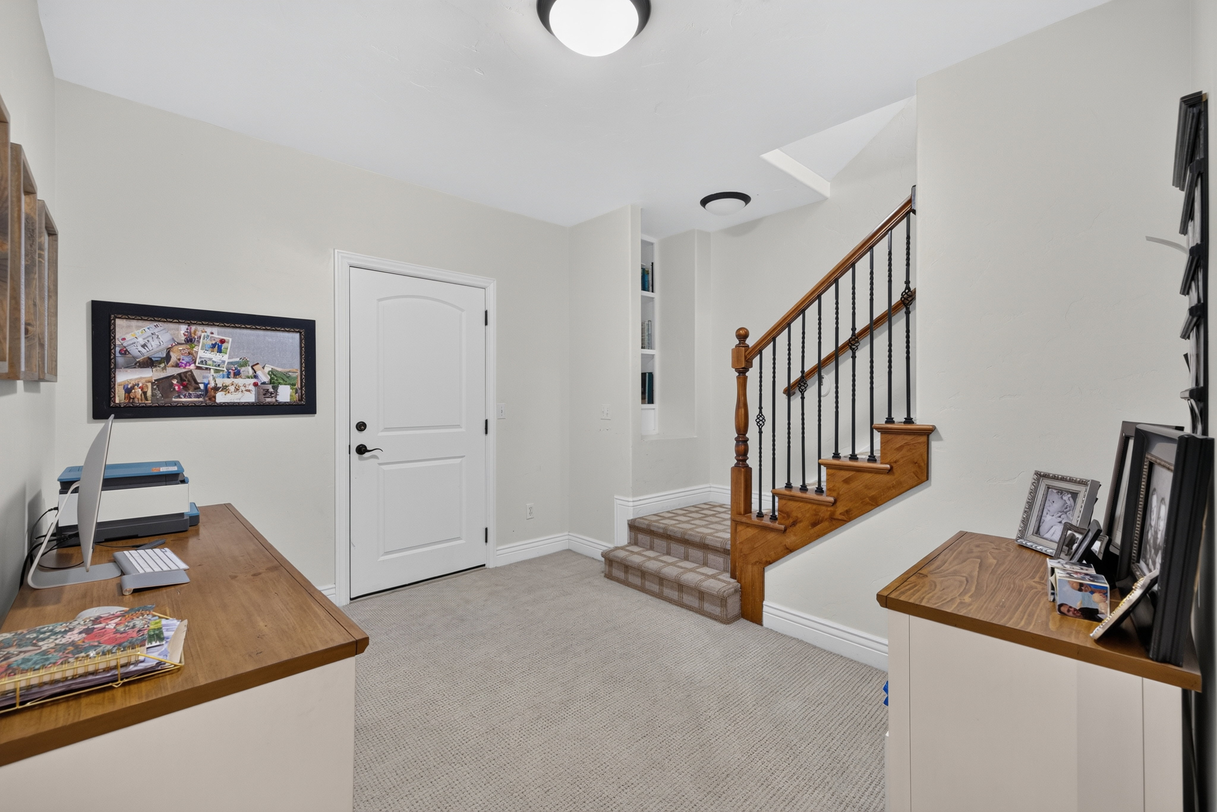 Architectural staircase featuring wood treads, a wood banister, and wrought iron balusters