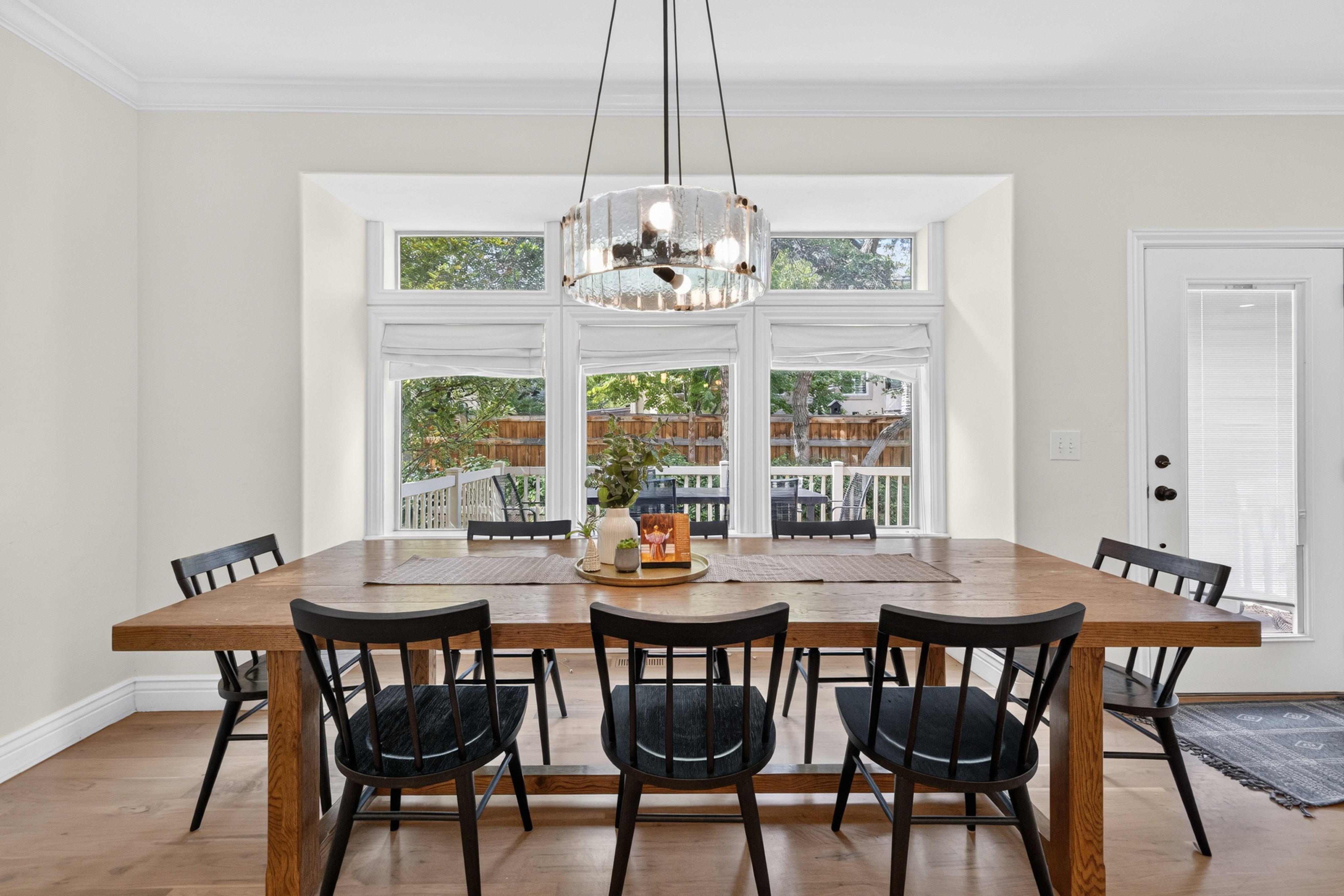 Dining area featuring a wood-finish dining table and wood-finish flooring