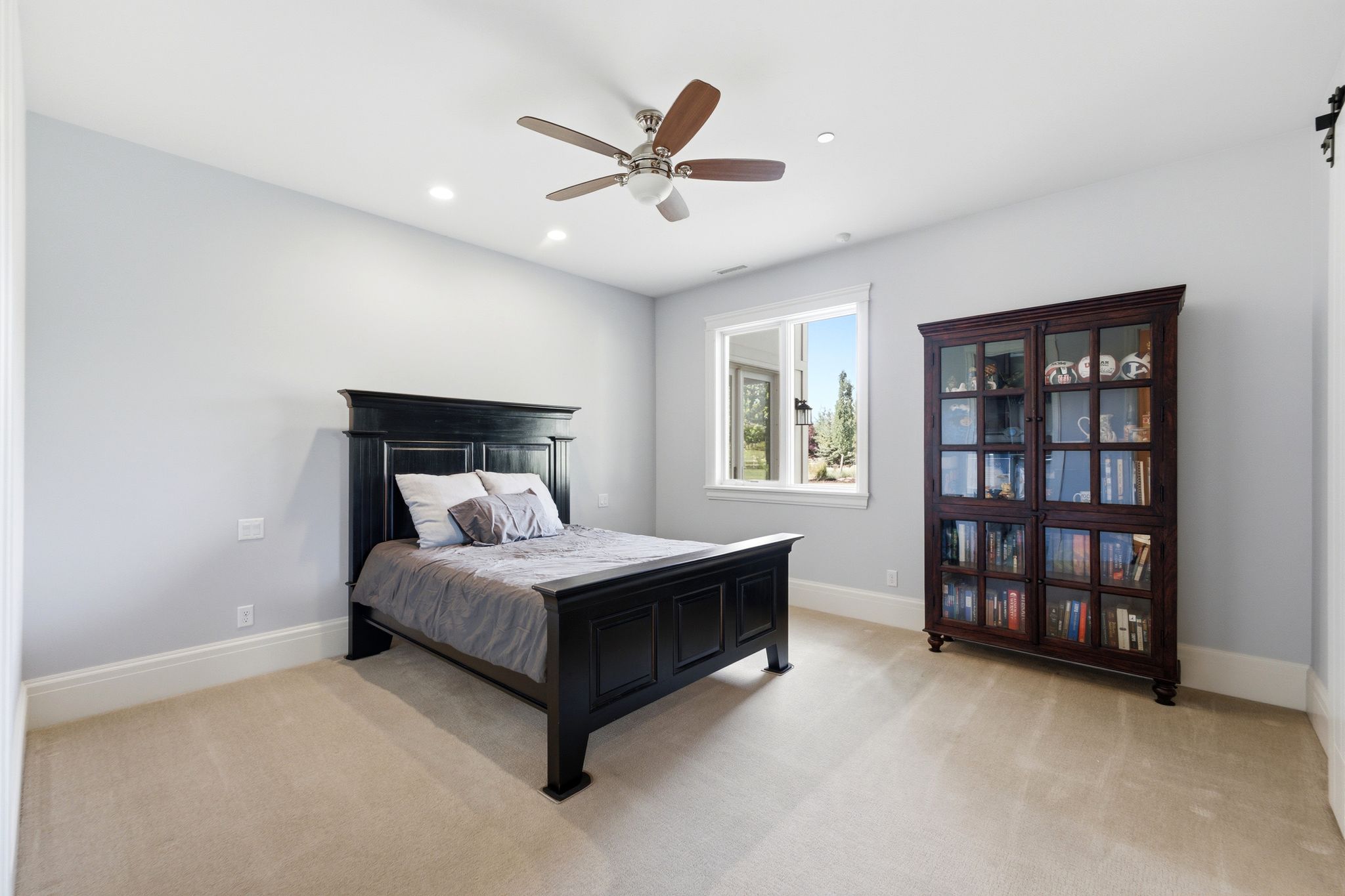 Carpeted room featuring light gray walls and white baseboards