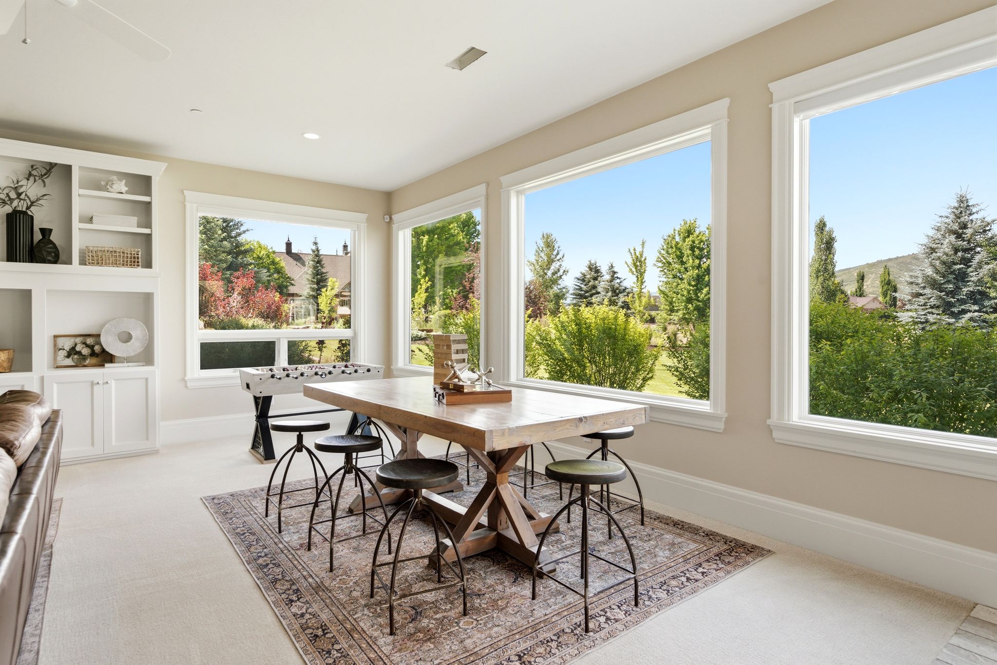 Room featuring multiple large windows, recessed lighting, and built-in white cabinetry
