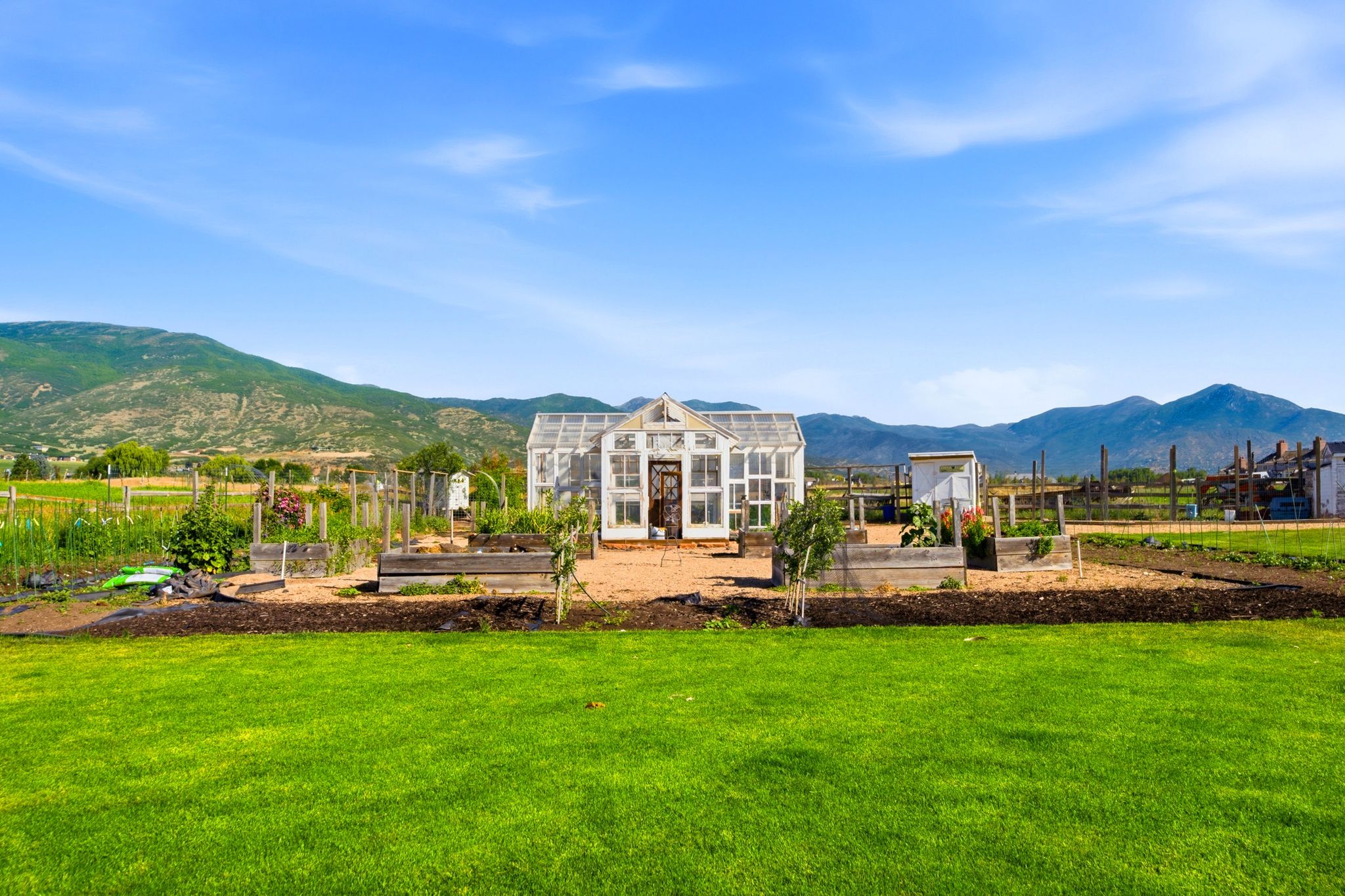 Expansive outdoor space featuring a glass greenhouse structure