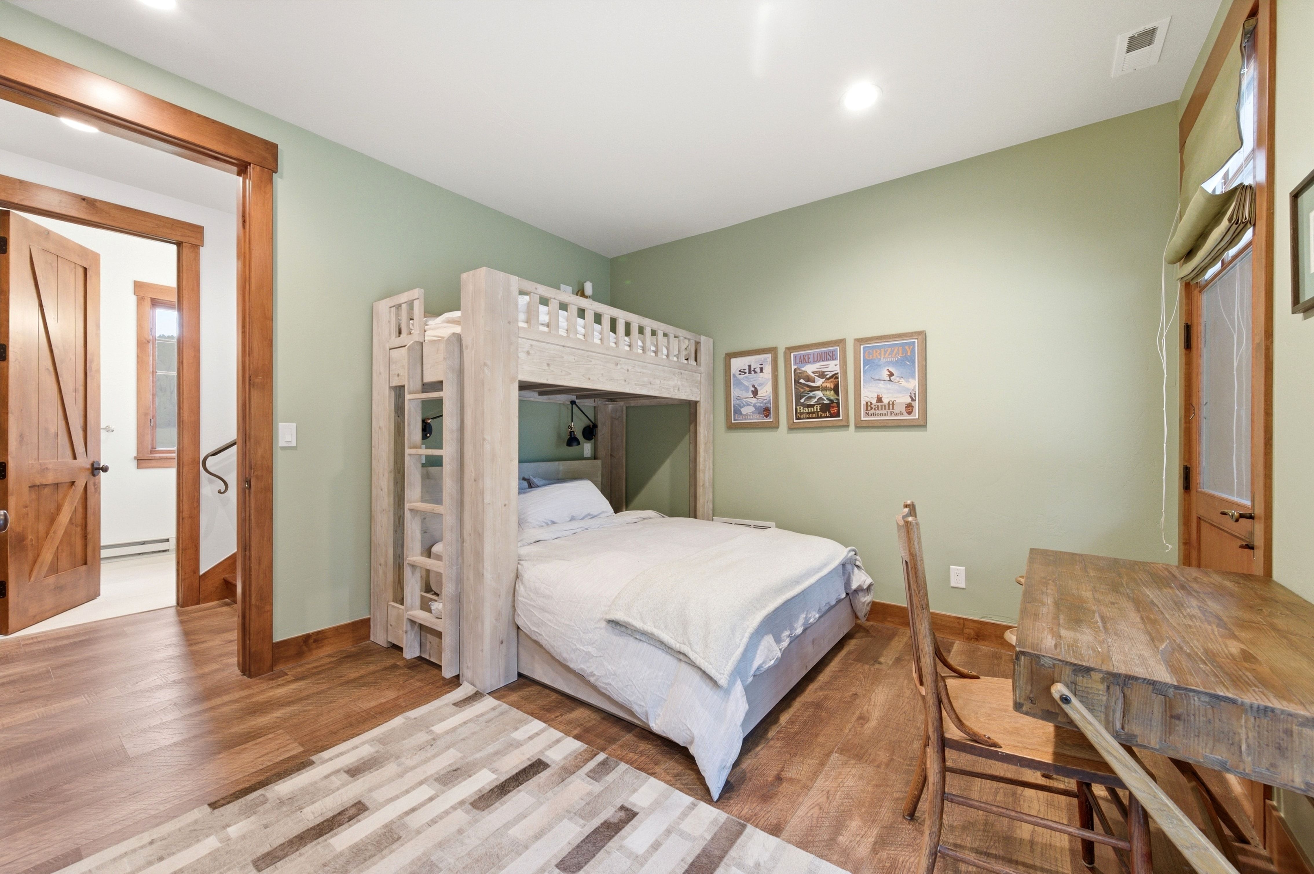 Room with wood-finish flooring and light green walls