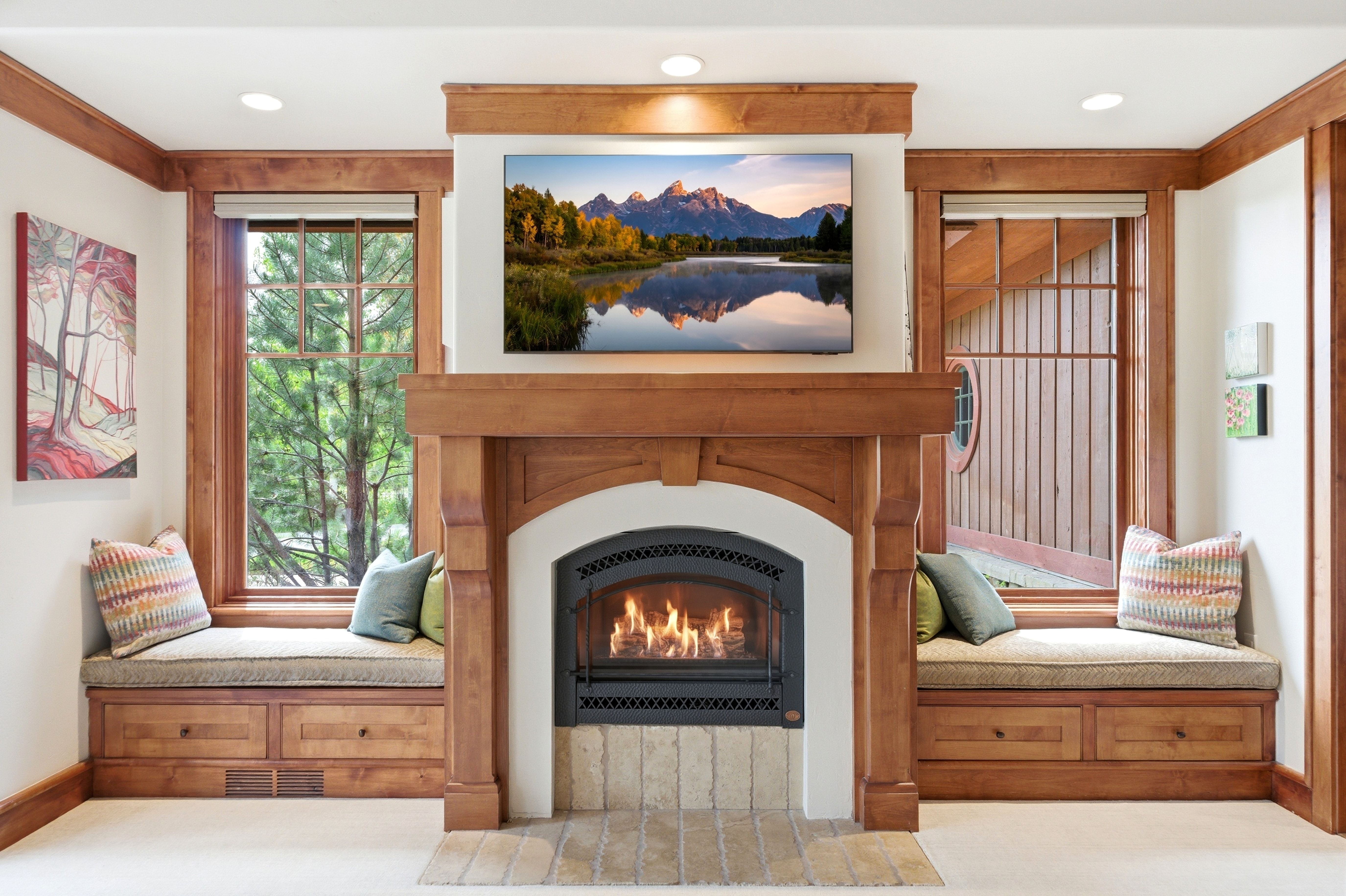 Wood-clad fireplace featuring a stone hearth and integrated wood mantel