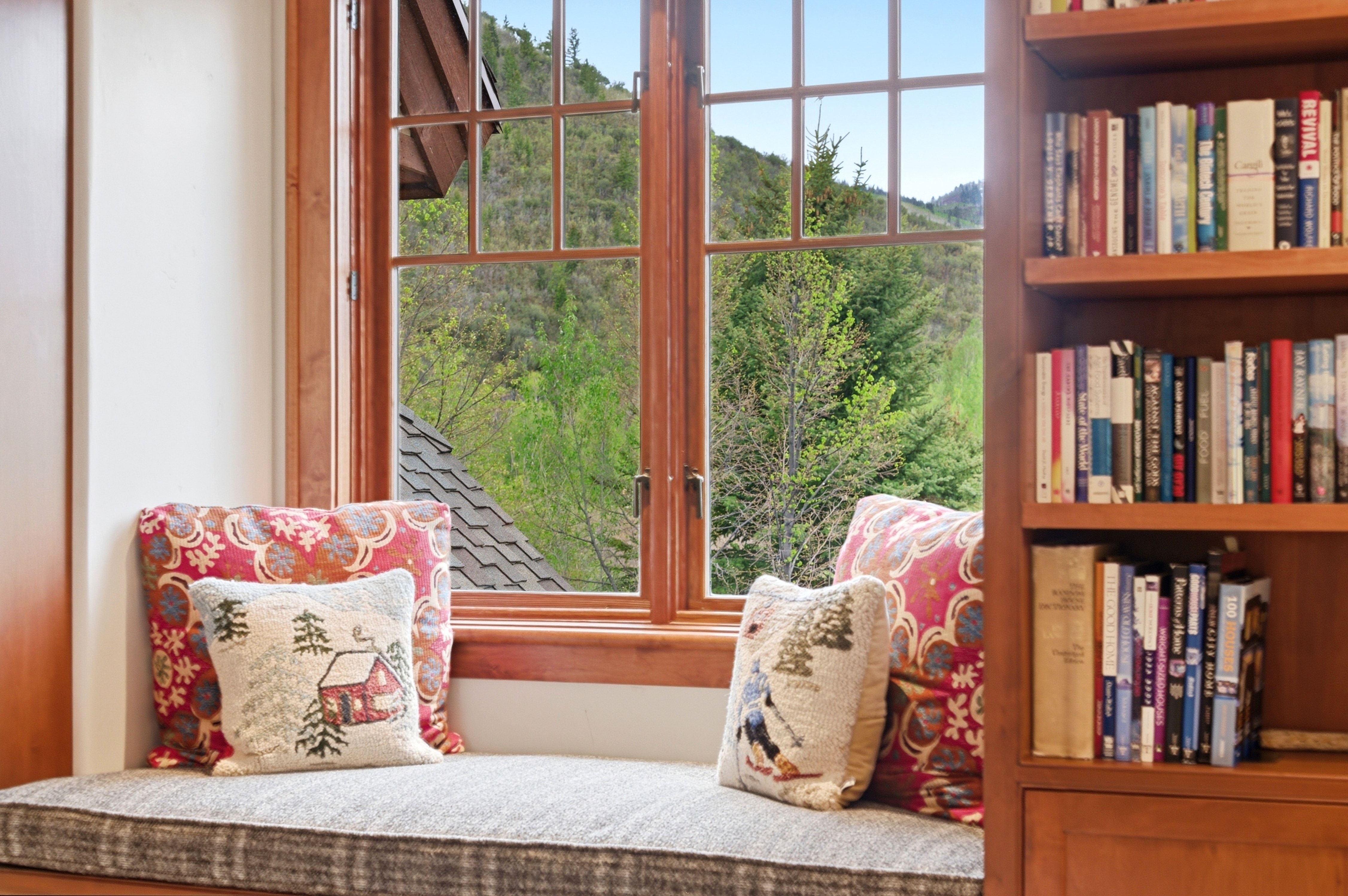 Integrated window seating with a wood-frame grid window