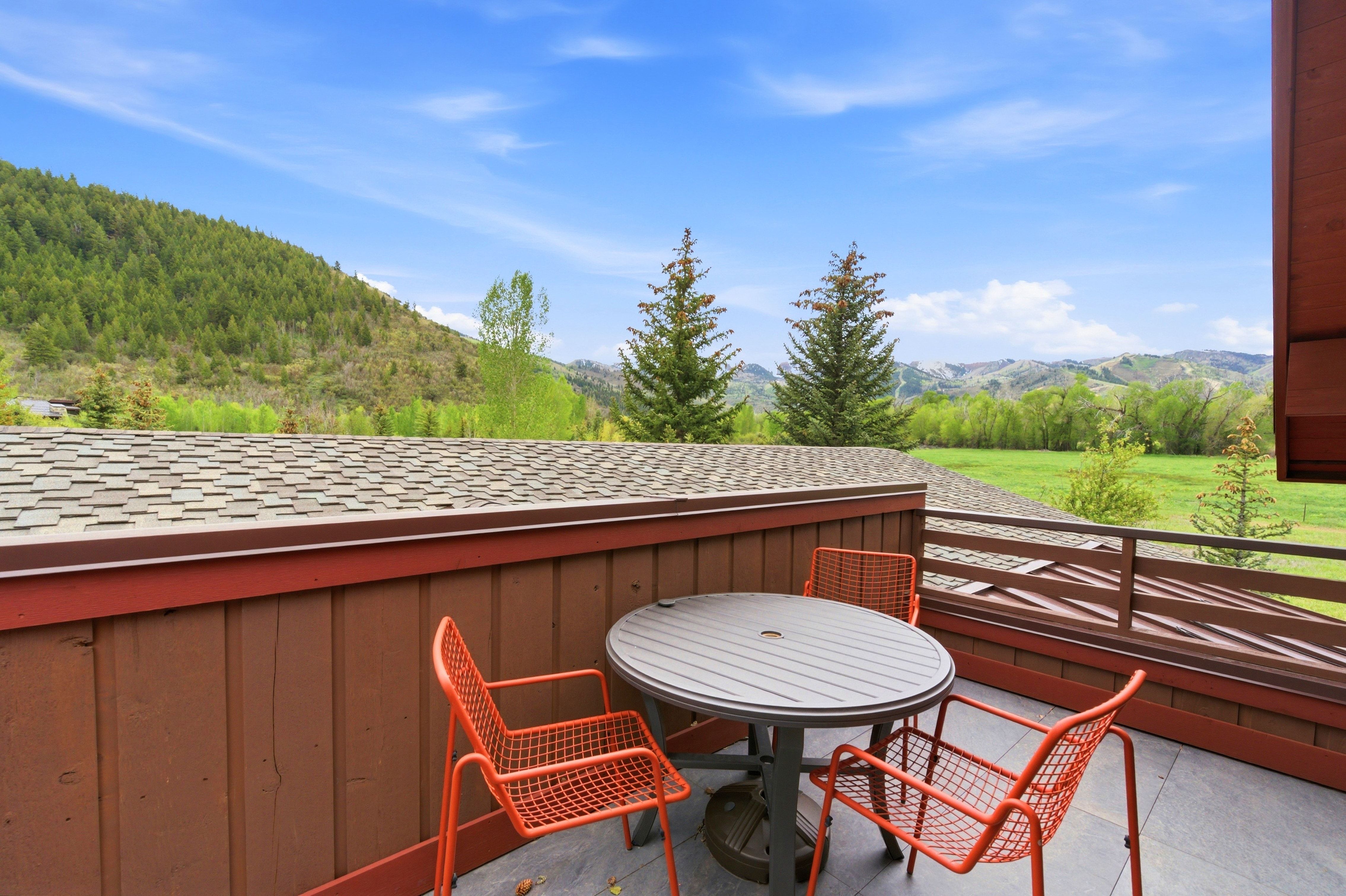Outdoor deck featuring brown vertical siding, a wood-finish railing, and gray tile flooring