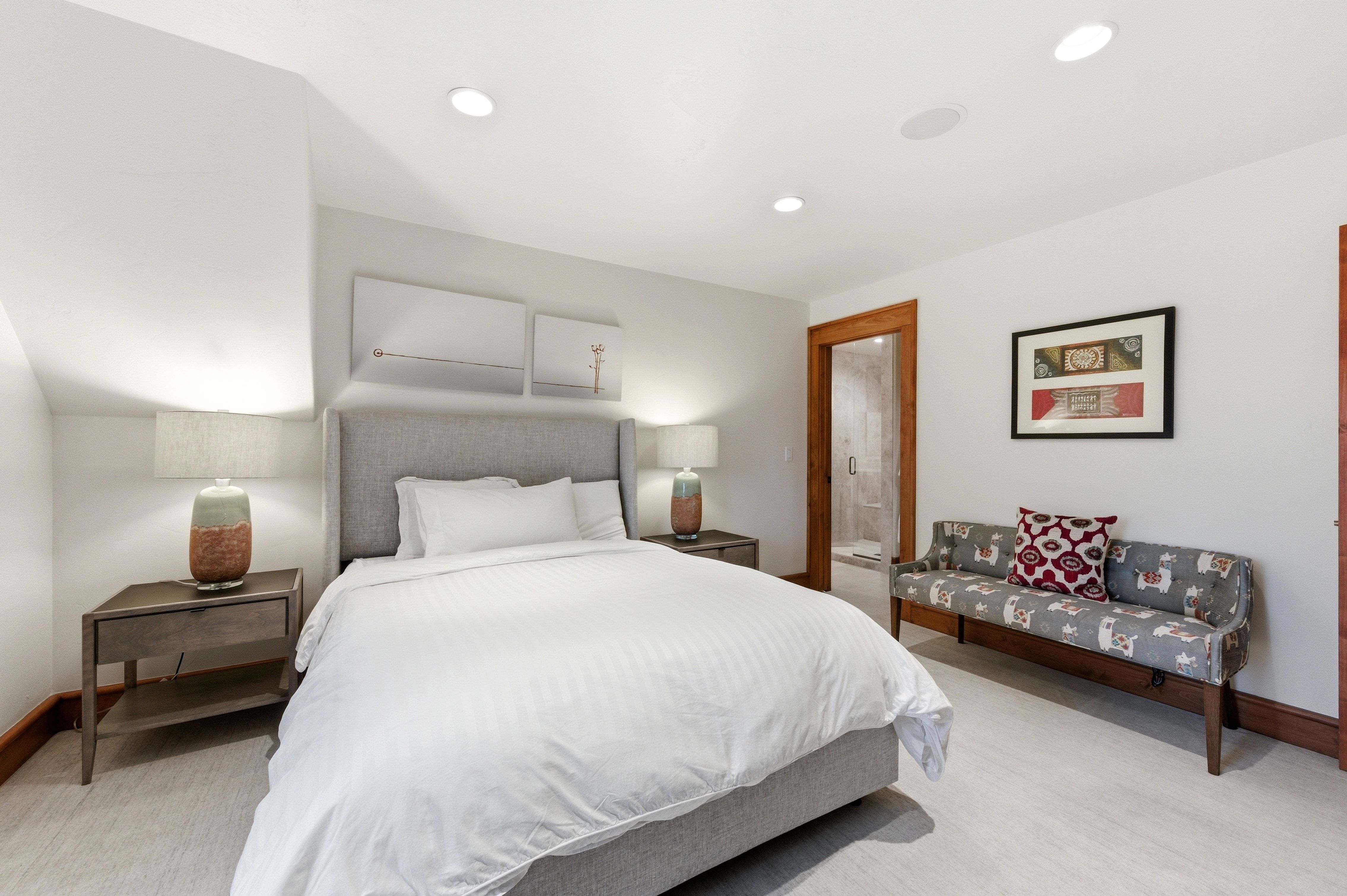 Light-toned wood-finish flooring with recessed ceiling lighting