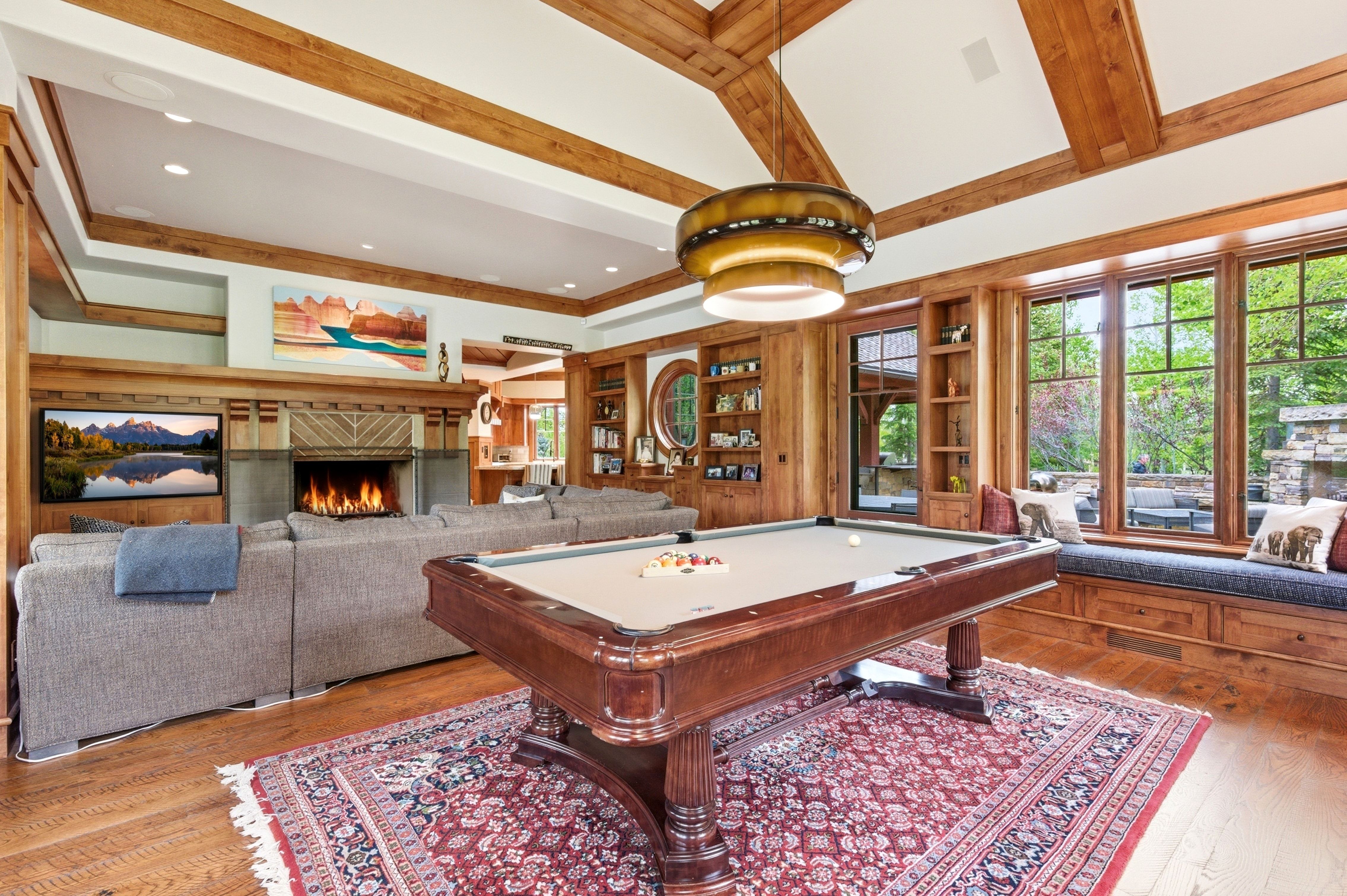 Spacious interior featuring exposed wood beams and wood-finish flooring