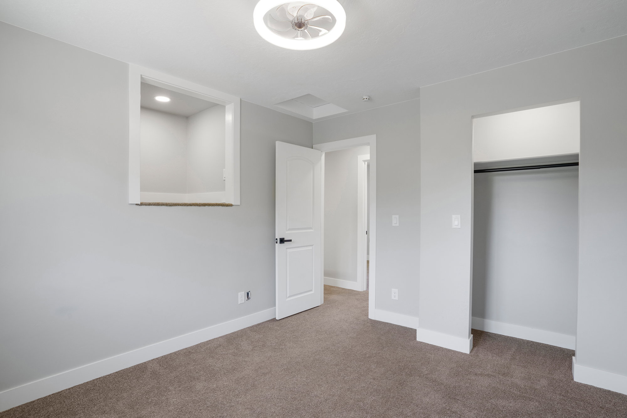 Plush carpeted flooring complementing light gray wall tones