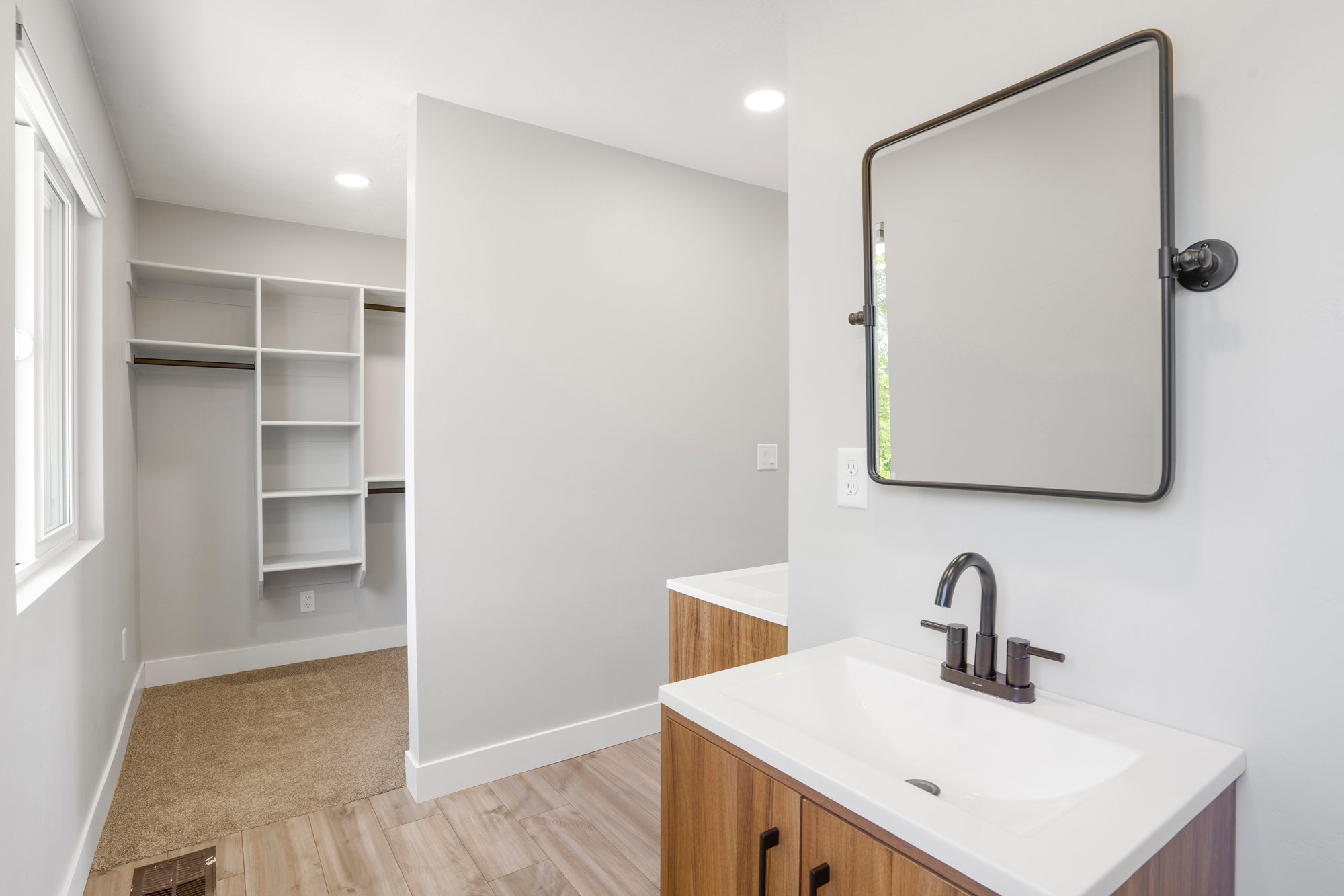 Bathroom vanity with a white countertop and a matte black faucet